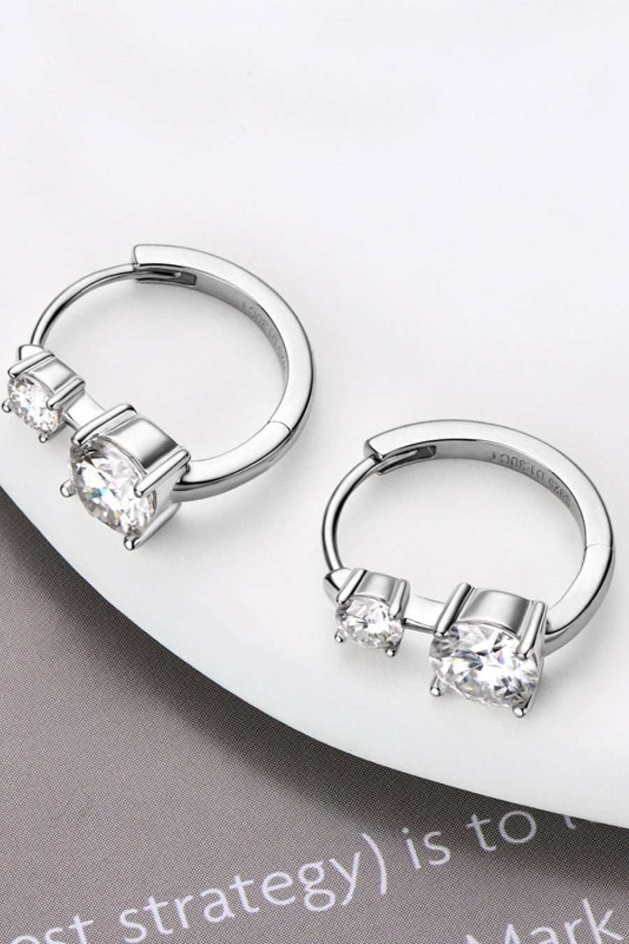 Sterling silver earrings with 1.3 carat moissanite stones, featuring a sparkling and elegant design.