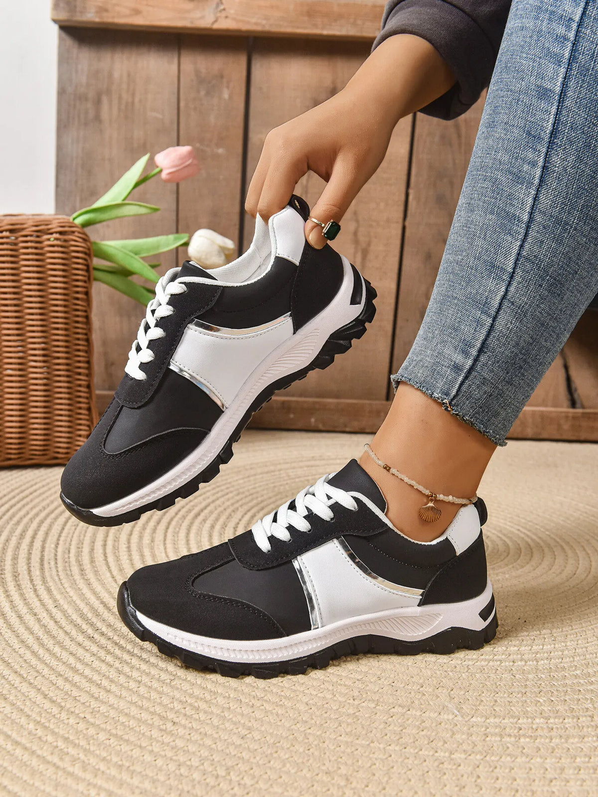 Contrast lace-up sneakers by Trendsi featuring stylish design, white and black color scheme, and durable rubber soles.