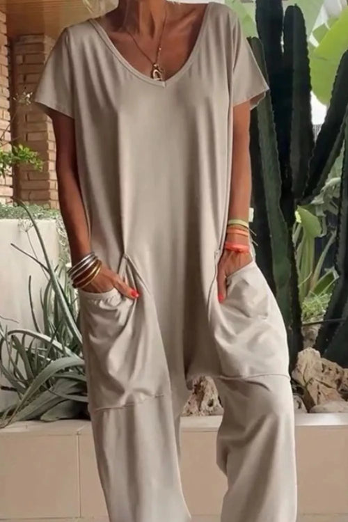 Plus size casual V-neck short sleeve jumpsuit with pockets by Trendsi, featuring a relaxed fit and stylish design.