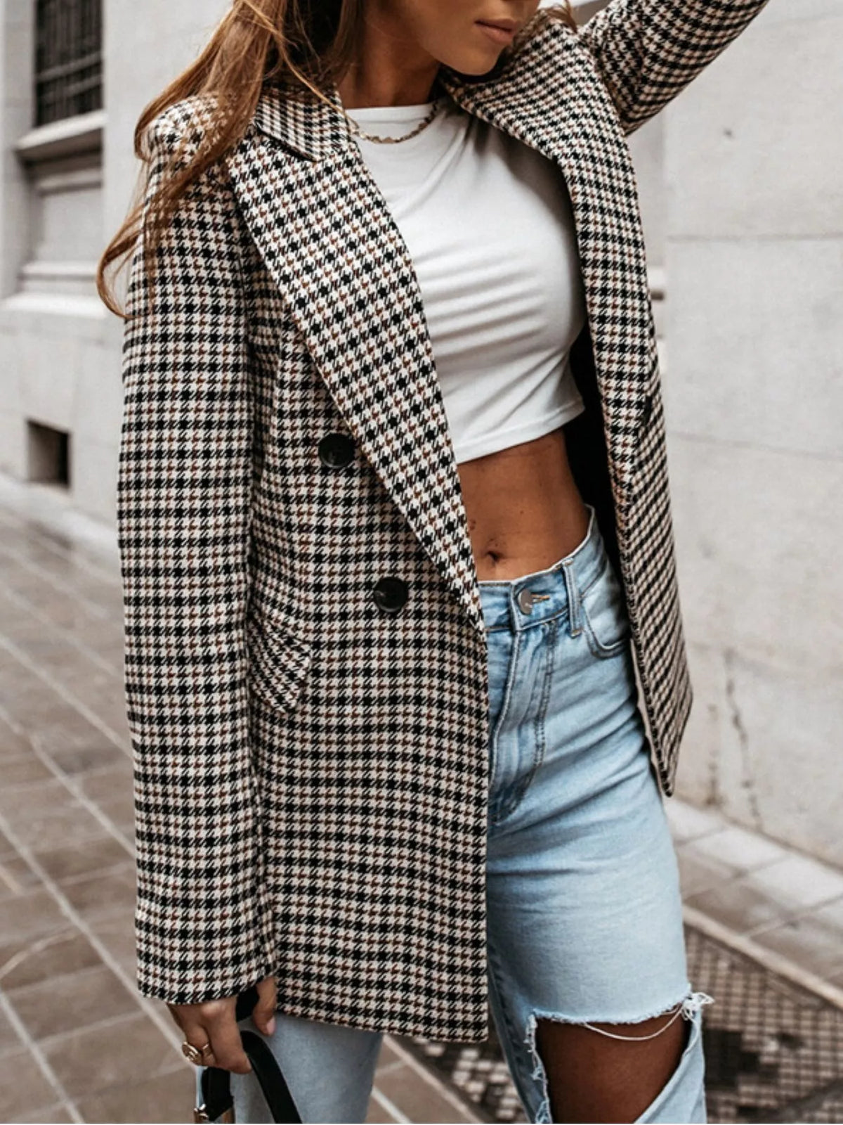 Classic houndstooth double-breasted blazer from Trendsi displayed on a hanger, showcasing its tailored fit and stylish pattern.