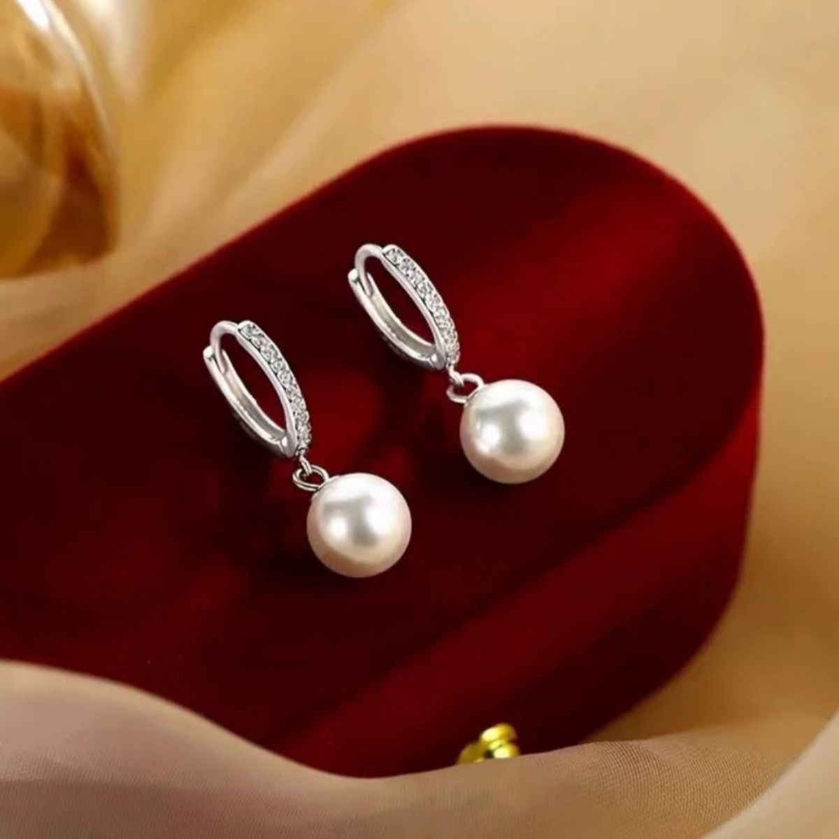 Pearl drop hoop earrings by Plush Fashion Hub featuring elegant gold hoops with hanging white pearl accents.