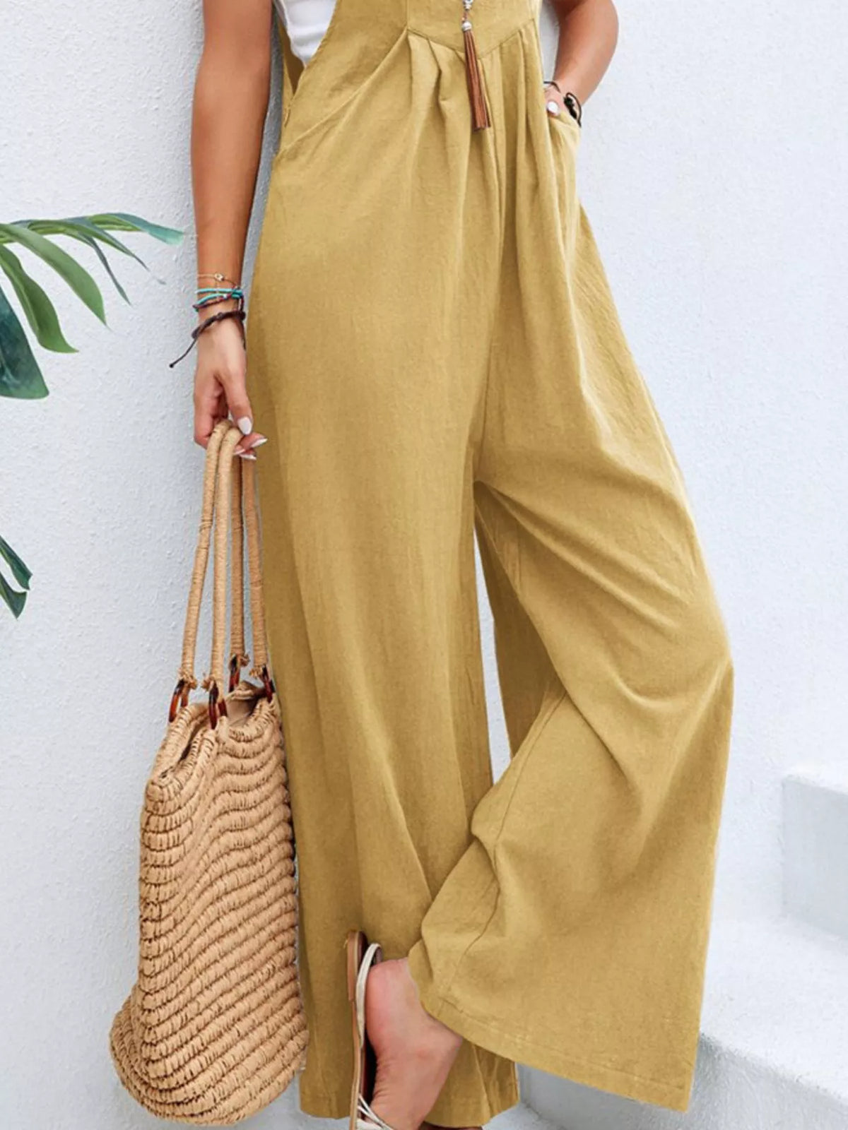 Plus size full size casual wide-leg jumpsuit with pockets by Plush Fashion Hub, featuring a relaxed fit and comfortable style.