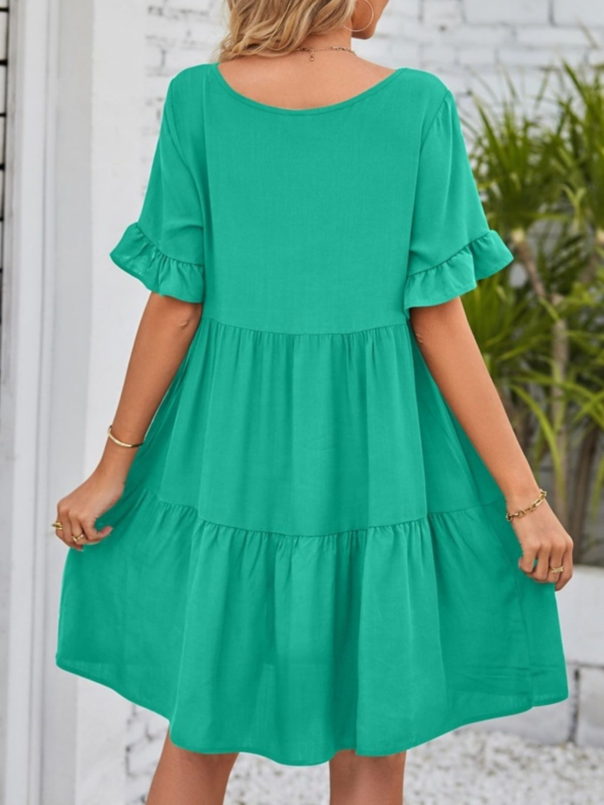 Lightweight rayon mini dress with ruffled sleeves, tiered design, and pockets, by Plush Fashion Hub, styled for a casual look.