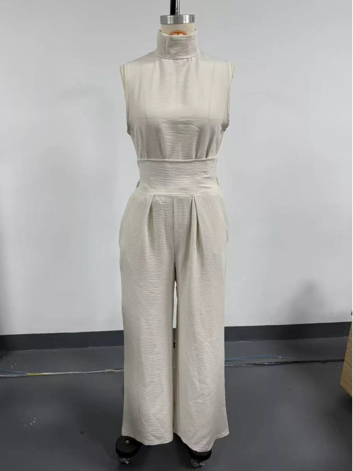 Plus size full length sleeveless wide-leg jumpsuit with smocked waist by Trendsi, shown on a model.