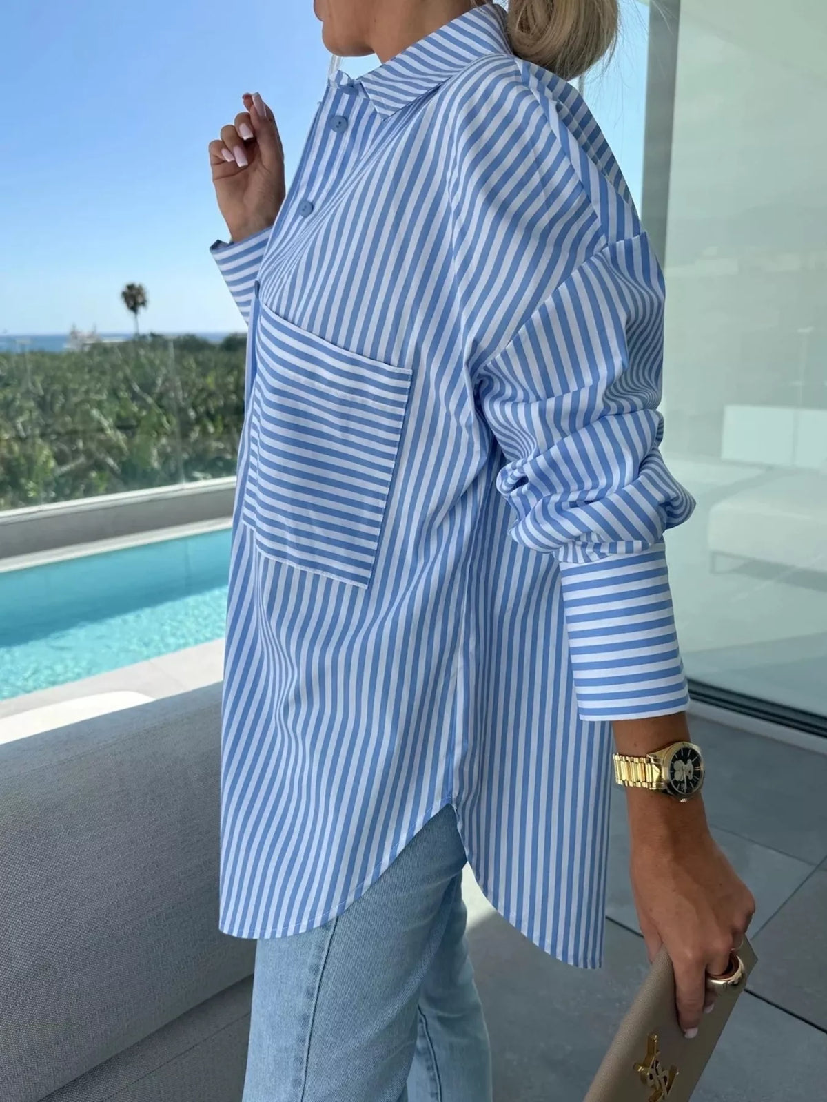 Women's long sleeve striped button-up shirt by Trendsi, featuring a classic design with vertical stripes and a relaxed fit.