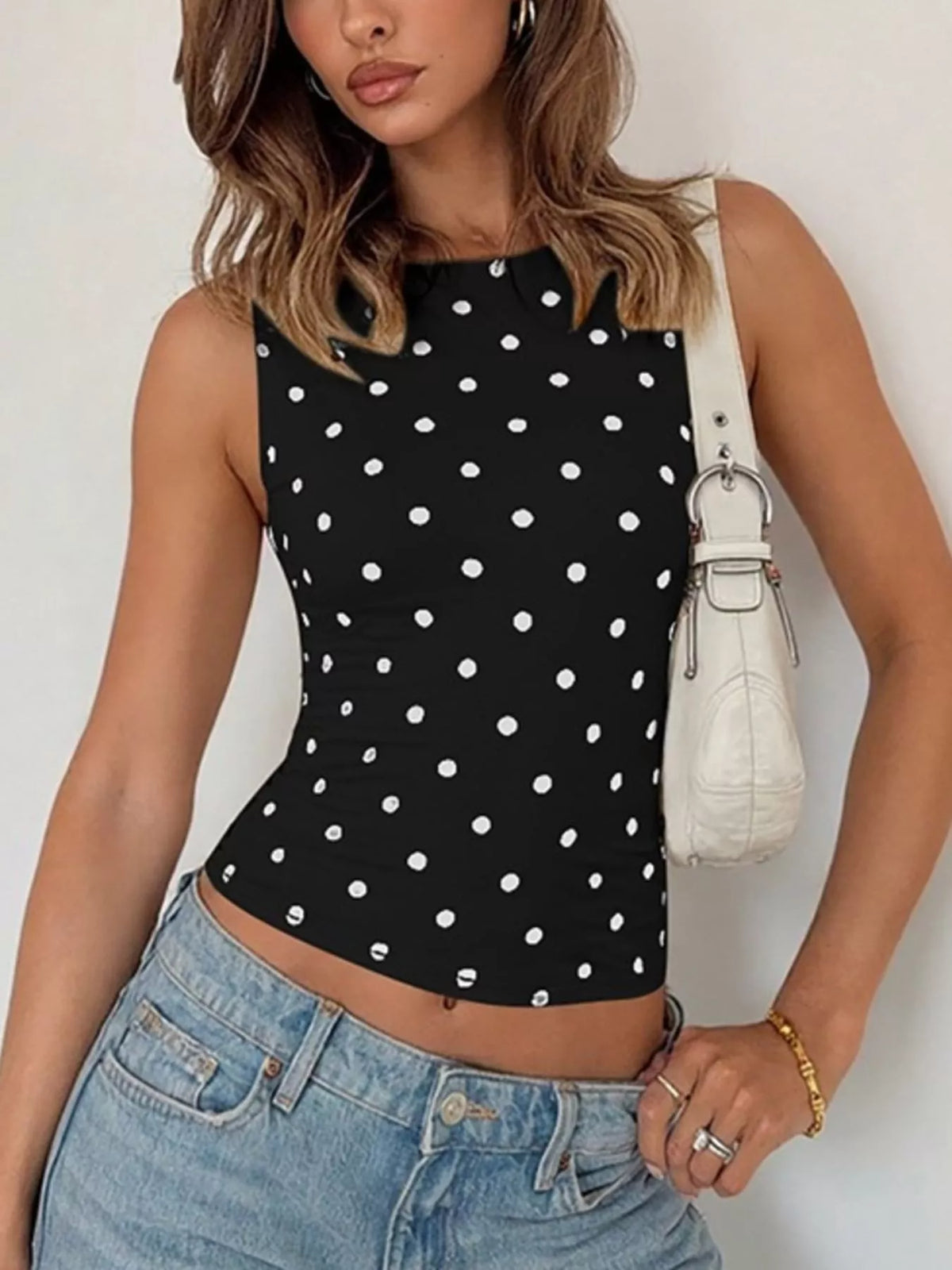 Polka dot tank top from Plush Fashion Hub featuring a sleeveless design with black and white polka dot pattern.