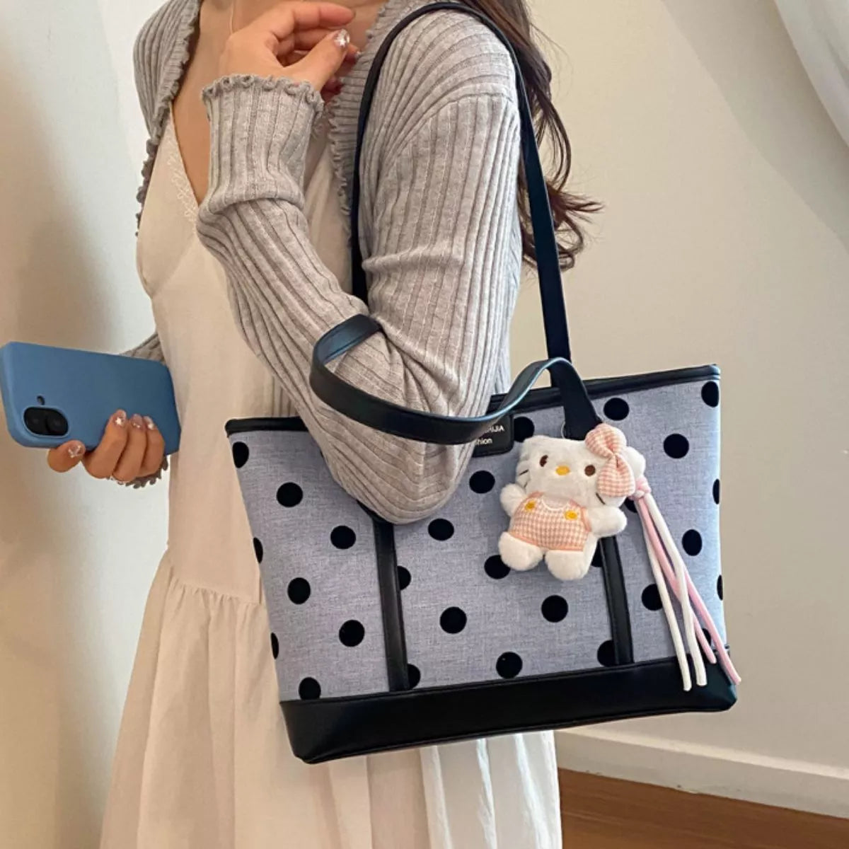 Polka dot shoulder handbag for women by Trendsi, featuring a stylish design with adjustable shoulder strap and spacious interior.