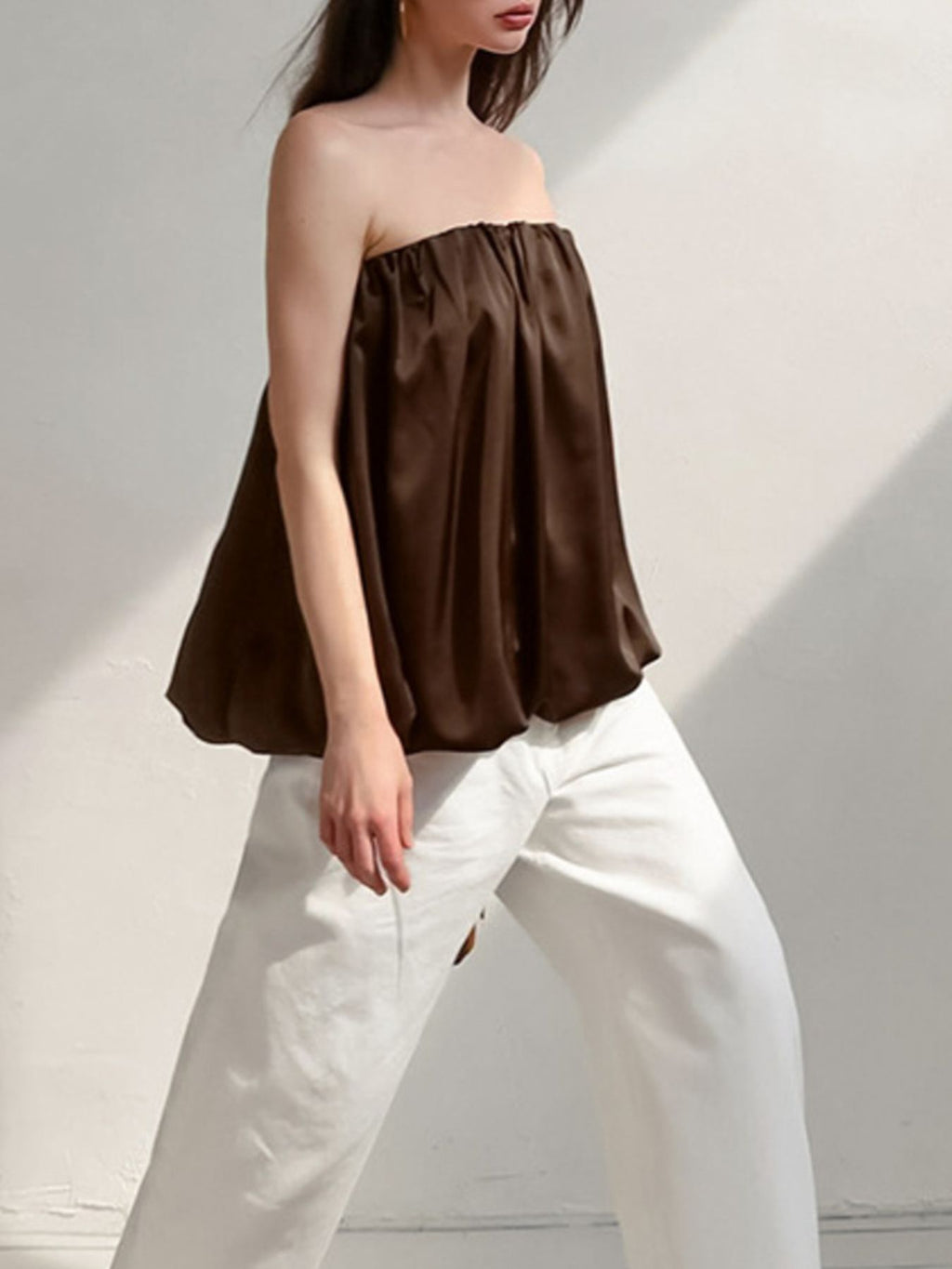 Women's strapless bubble hem tube top from Trendsi, sleek minimalist crop top with a trendy, fitted design.