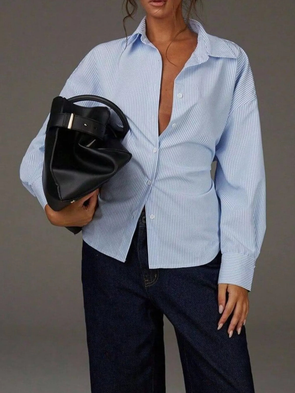 Casual striped button-down shirt by Trendsi, featuring a classic collar and long sleeves, displayed flat on a white background.
