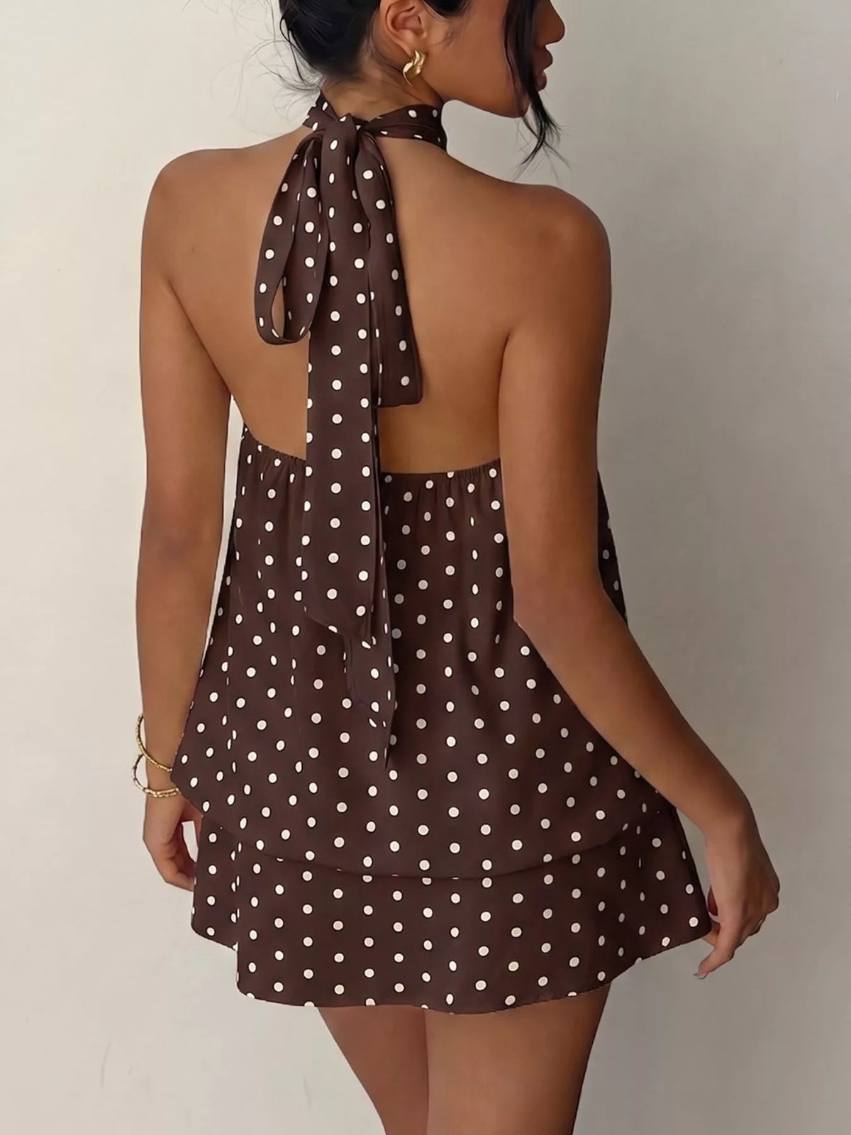 Polka dot halter neck mini dress by Plush Fashion Hub, featuring a stylish design with a fitted bodice and flared skirt.