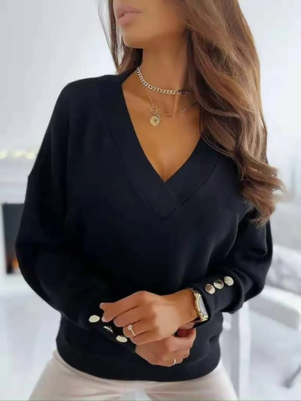 V-neck long sleeve sweatshirt by Trendsi featuring a relaxed fit, soft fabric, and a casual style perfect for everyday wear.
