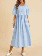 Plus size midi dress by FitiqueFit featuring a round neck and front pockets, perfect for casualwear and comfortable style.