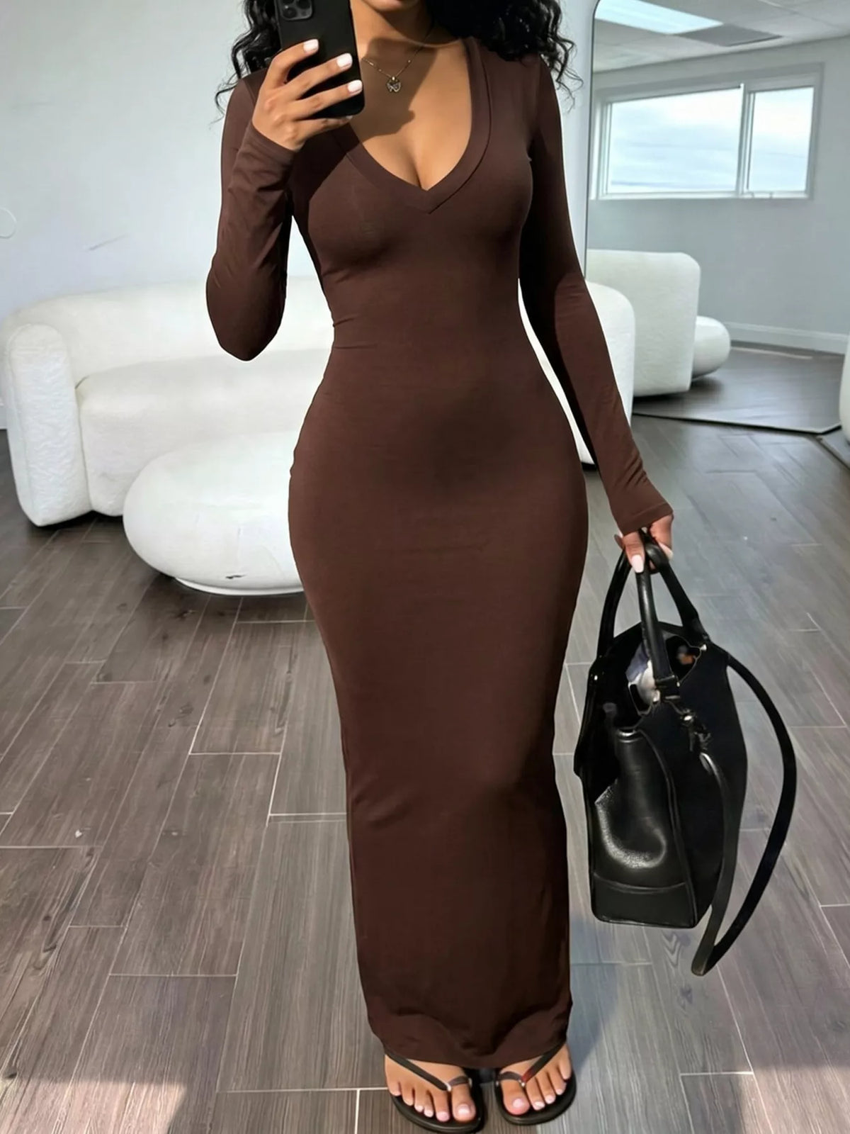Trendsi long sleeve V-neck ruched maxi dress in black, featuring fitted waist and flowing skirt, perfect for elegant occasions.