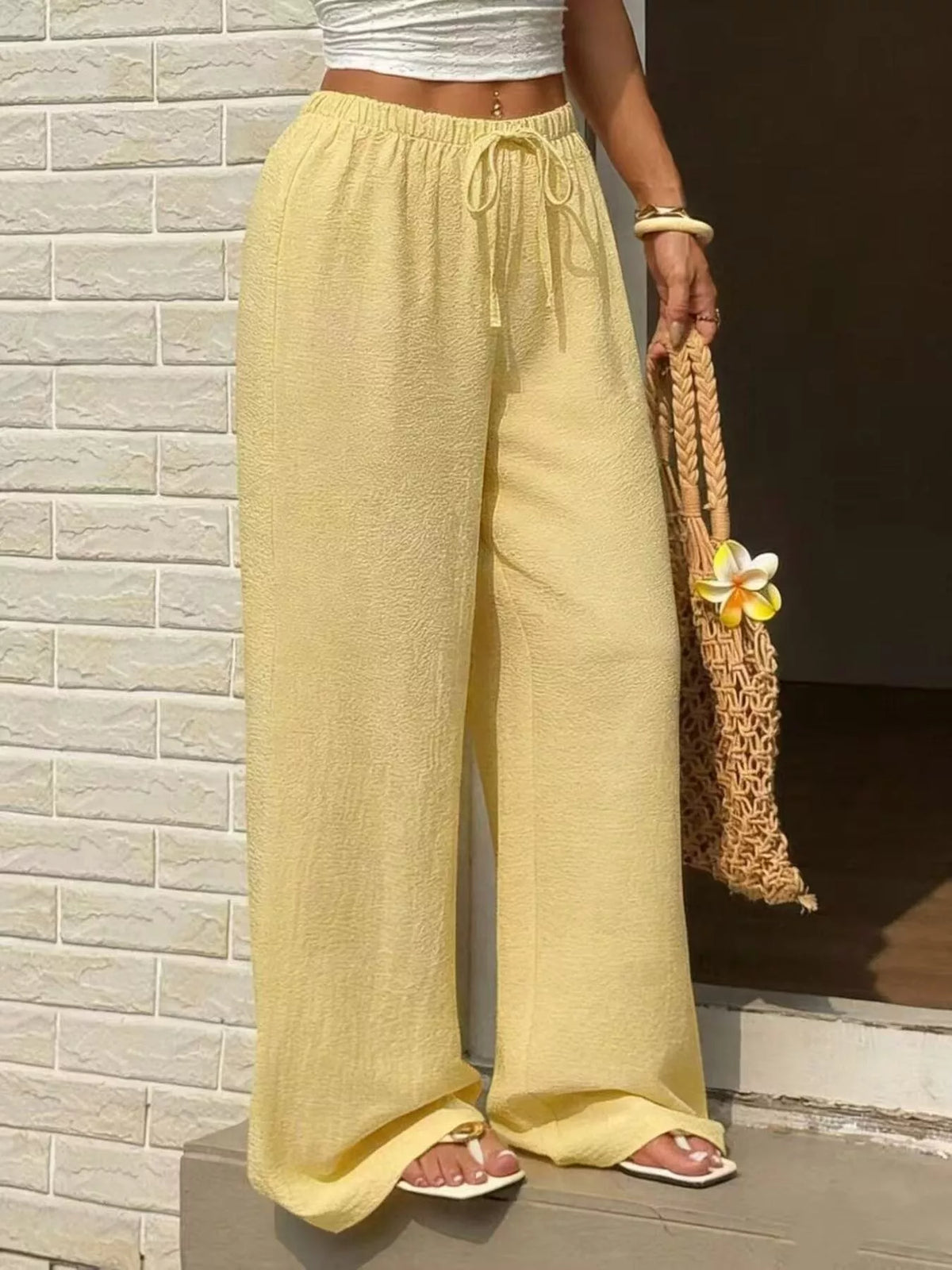 Plus size high-waisted wide-leg pants from Plush Fashion Hub, shown in dark fabric with a relaxed fit and flowing silhouette.
