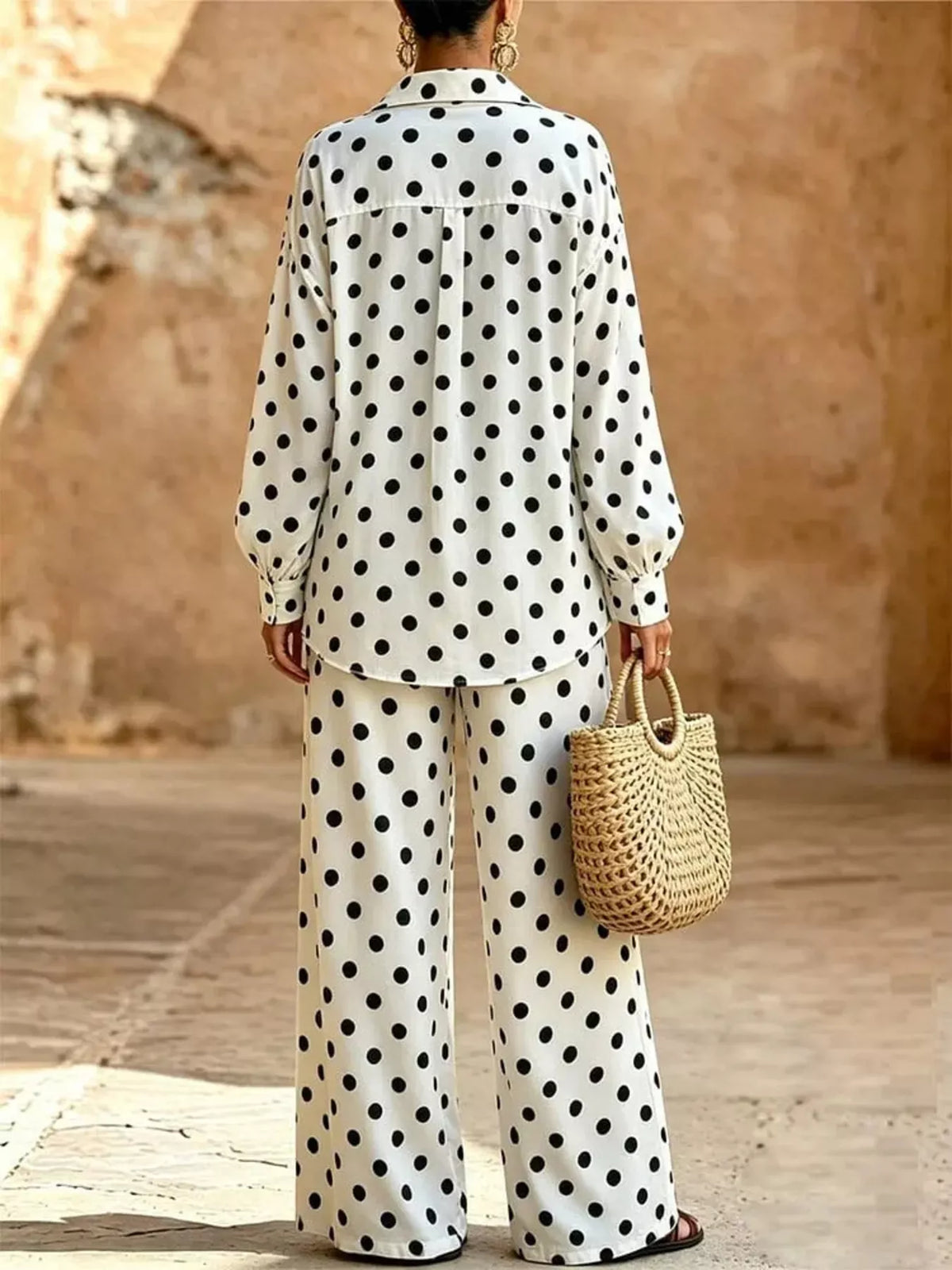 Plus size polka dot shirt and wide-leg pants set by Trendsi, featuring a stylish matching top and bottom ensemble.