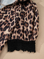Leopard print short sleeve blouse from Trendsi with lace trim, button front, and relaxed fit, displayed on a hanger.