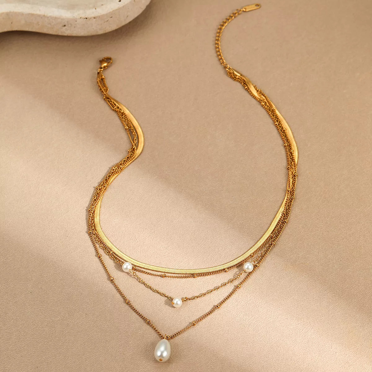 18K gold-plated four-layered pearl necklace with white pearls and gold accents, elegant jewelry piece from Plush Fashion Hub