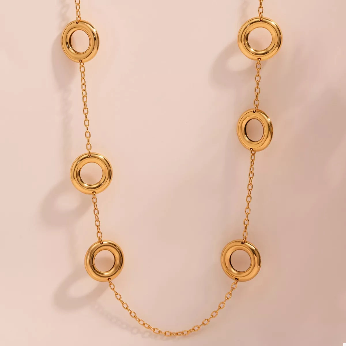 Gold-plated circle chain statement necklace from Plush Fashion Hub, showing a bold, stylish jewelry piece with interconnected circular links.