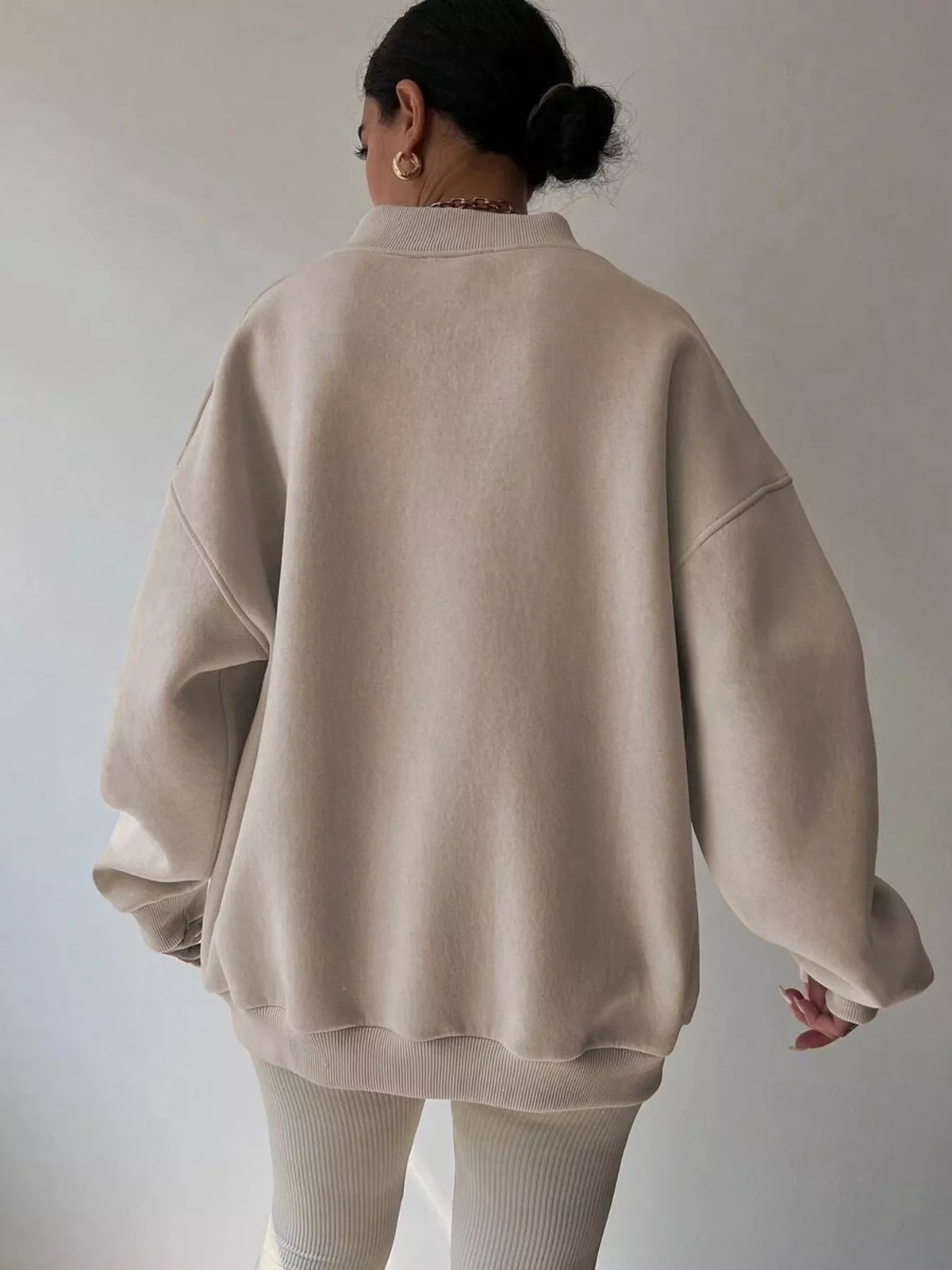 Long sleeve dropped shoulder oversized sweatshirt in soft fabric, featuring a relaxed fit and trendy style by Trendsi.