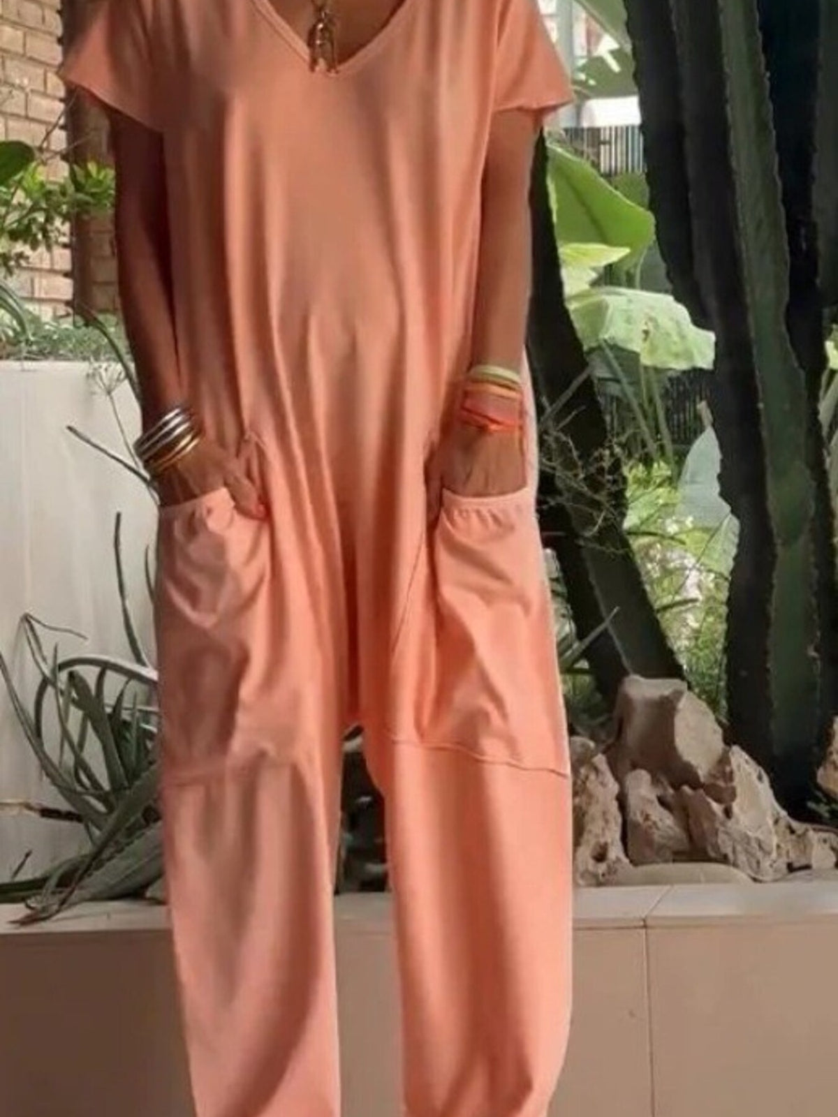 Plus size loose fit V-neck short sleeve jumpsuit with wide-leg design, from Trendsi, shown in a full-size, relaxed fit style.