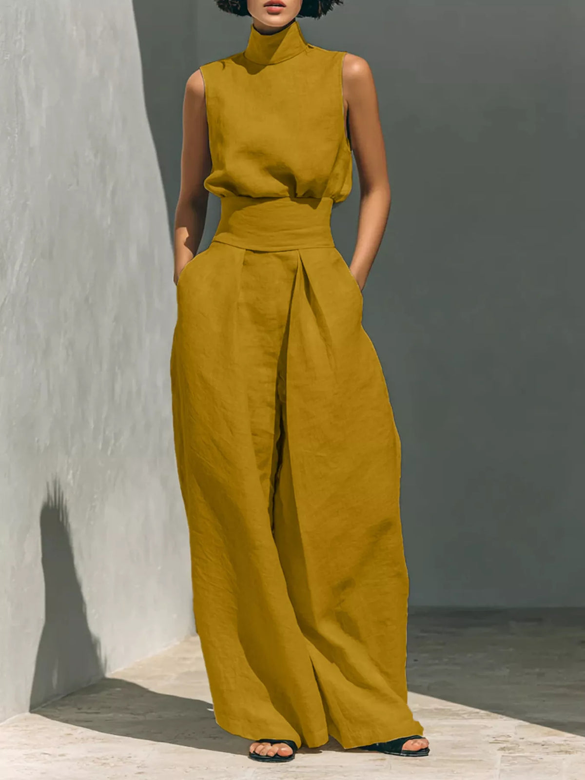 Plus size full-length sleeveless wide-leg jumpsuit with smocked waist, trendy fashion by Trendsi, shown in black fabric.