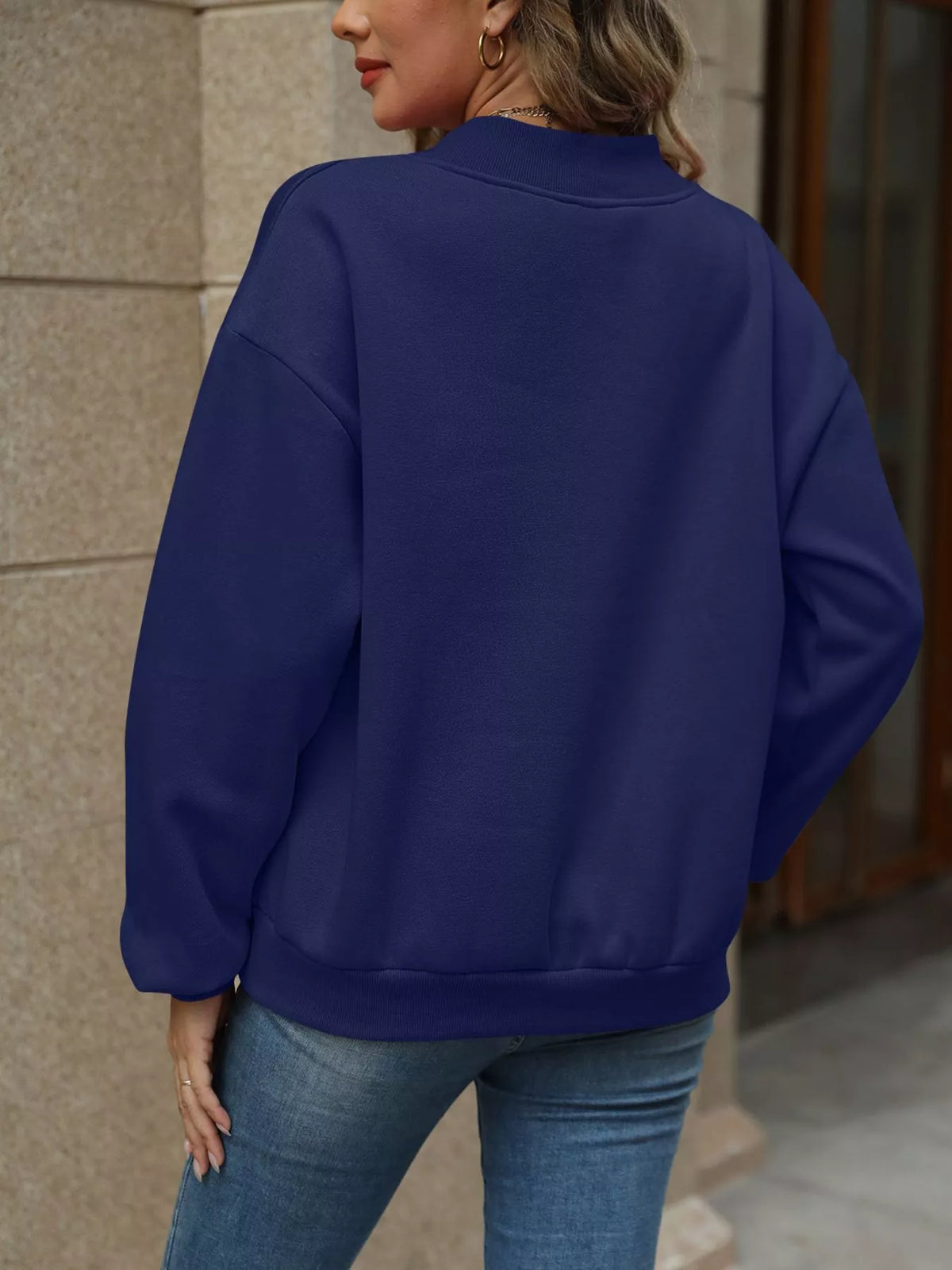 V-neck solid color casual sweatshirt by Trendsi, featuring a comfortable fit and soft fabric, shown in a neutral tone.
