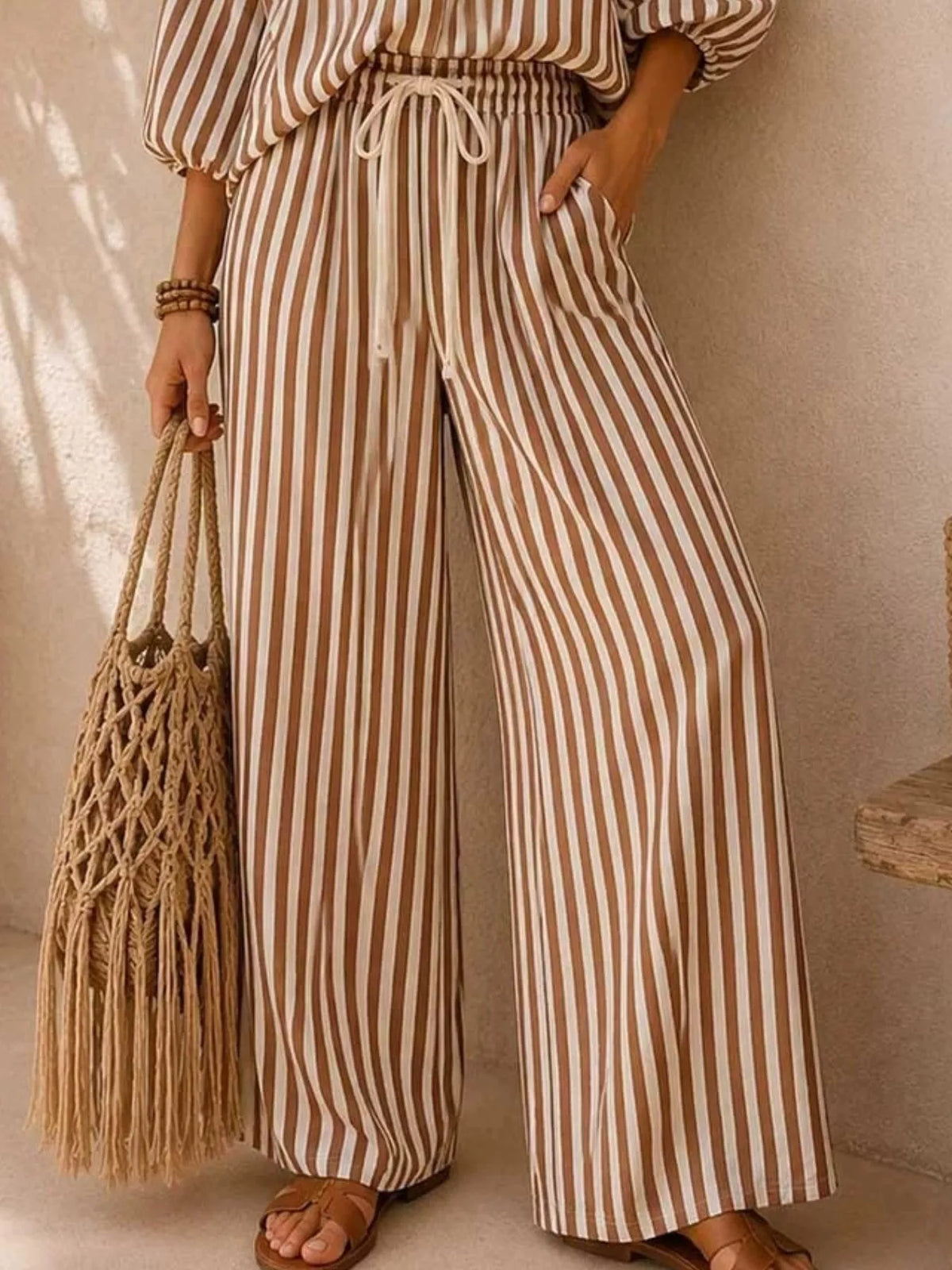 Plus size striped puff sleeve shirt and wide-leg drawstring pants set by Trendsi, featuring a stylish coordinated matching outfit.
