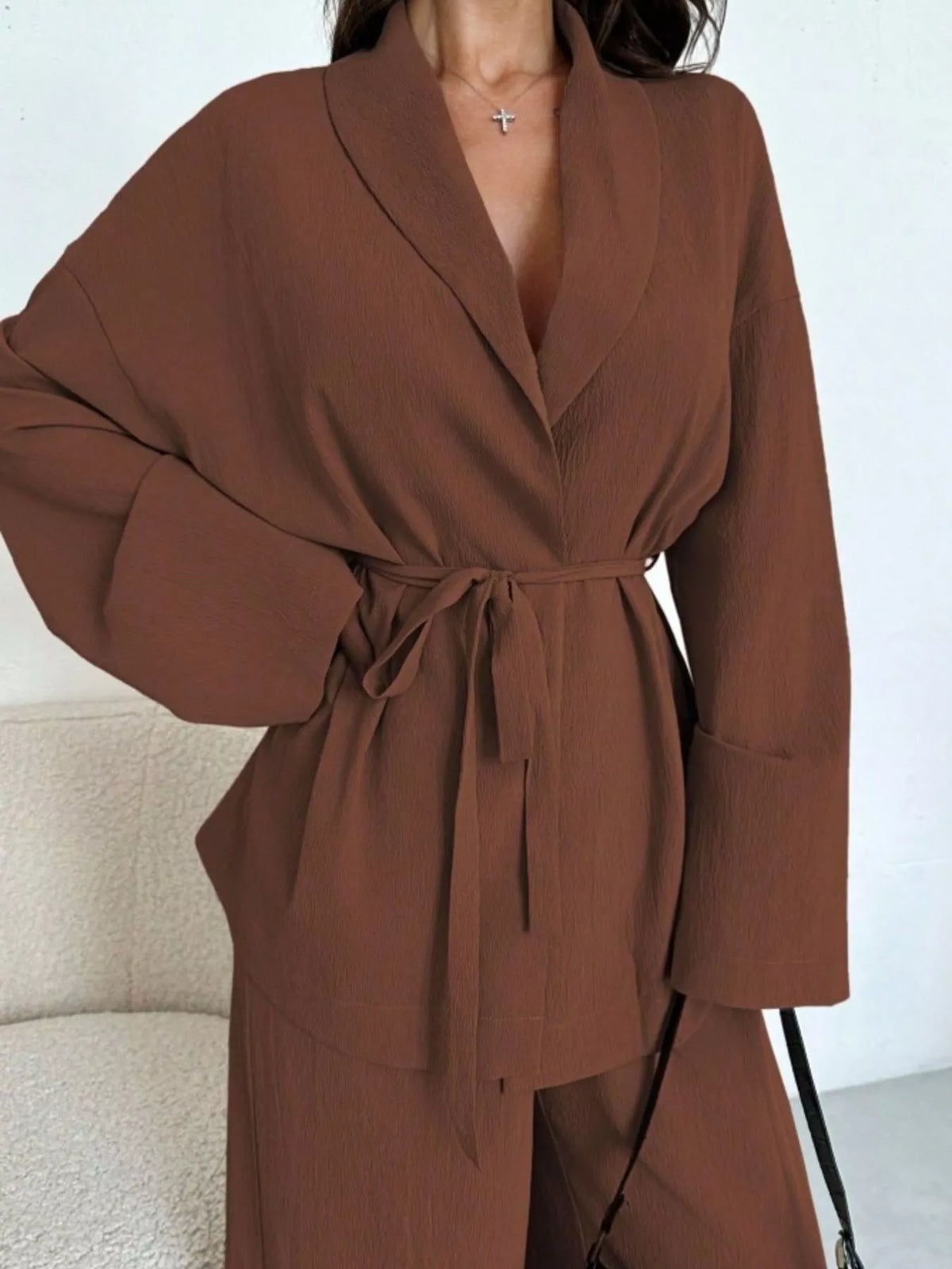 Textured tie waist top and wide-leg pants set for women, stylish fashion ensemble by Trendsi, shown on a model.