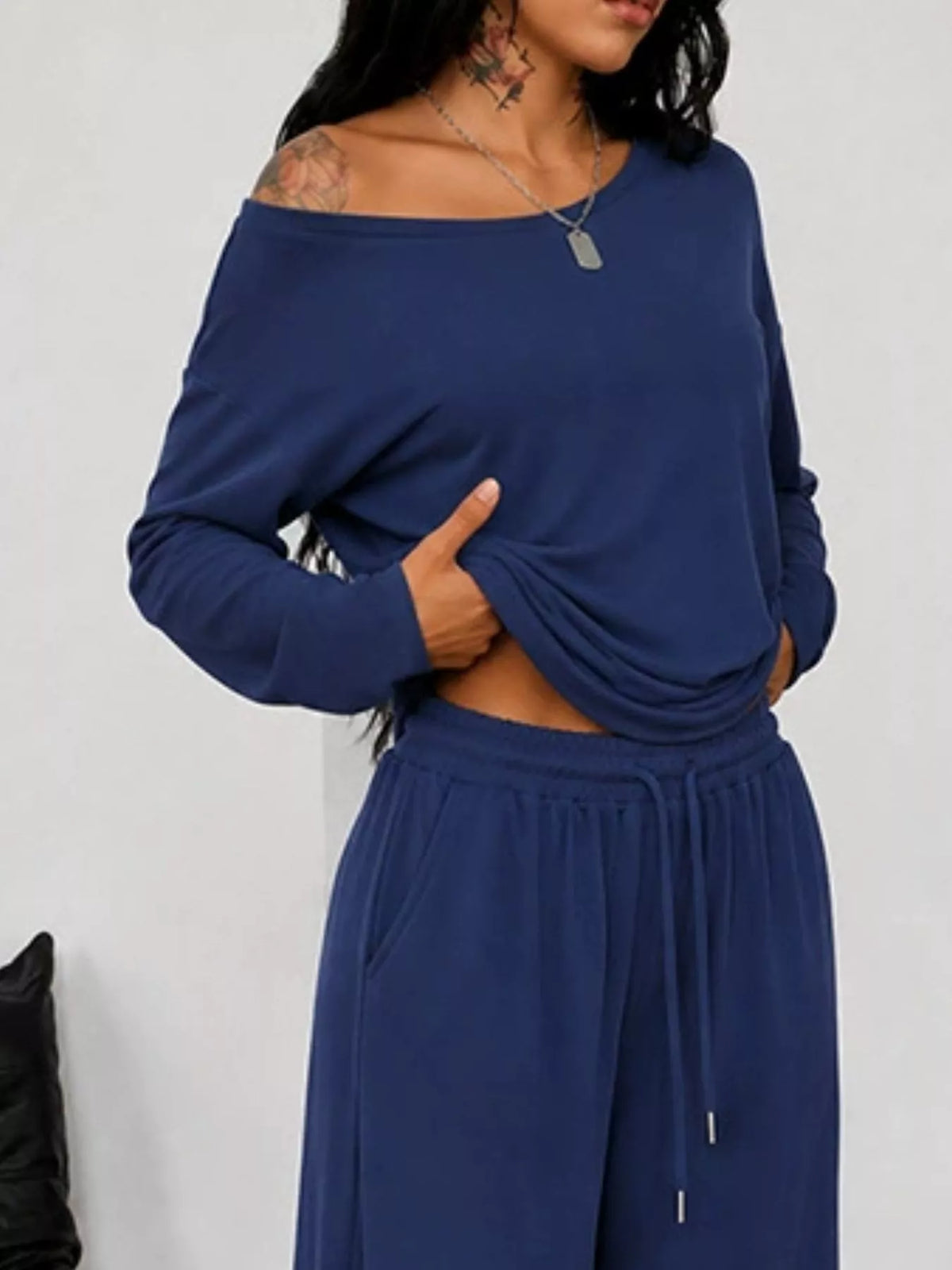 Plus size one-shoulder top and drawstring pants set by Trendsi, featuring a stylish matching set with a modern fit.