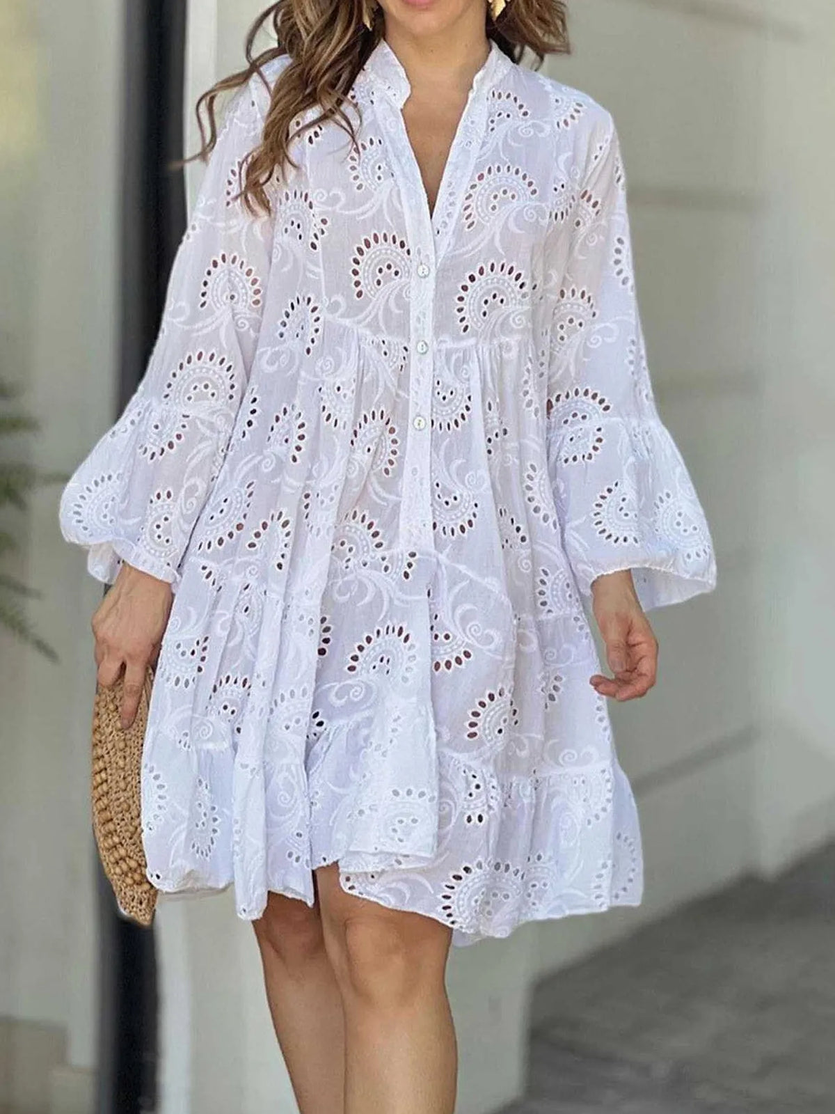 Plus size tiered dress with eyelet ruffled hem, featuring a flowing design and floral details, perfect for casual or summer wear.