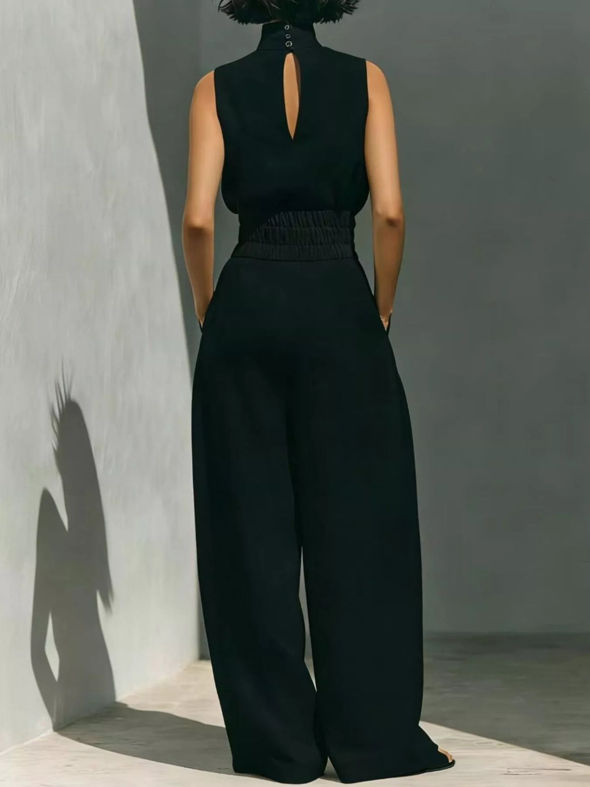 Plus size sleeveless wide-leg jumpsuit with smocked waist, featuring a full-length design and relaxed fit from Trendsi.