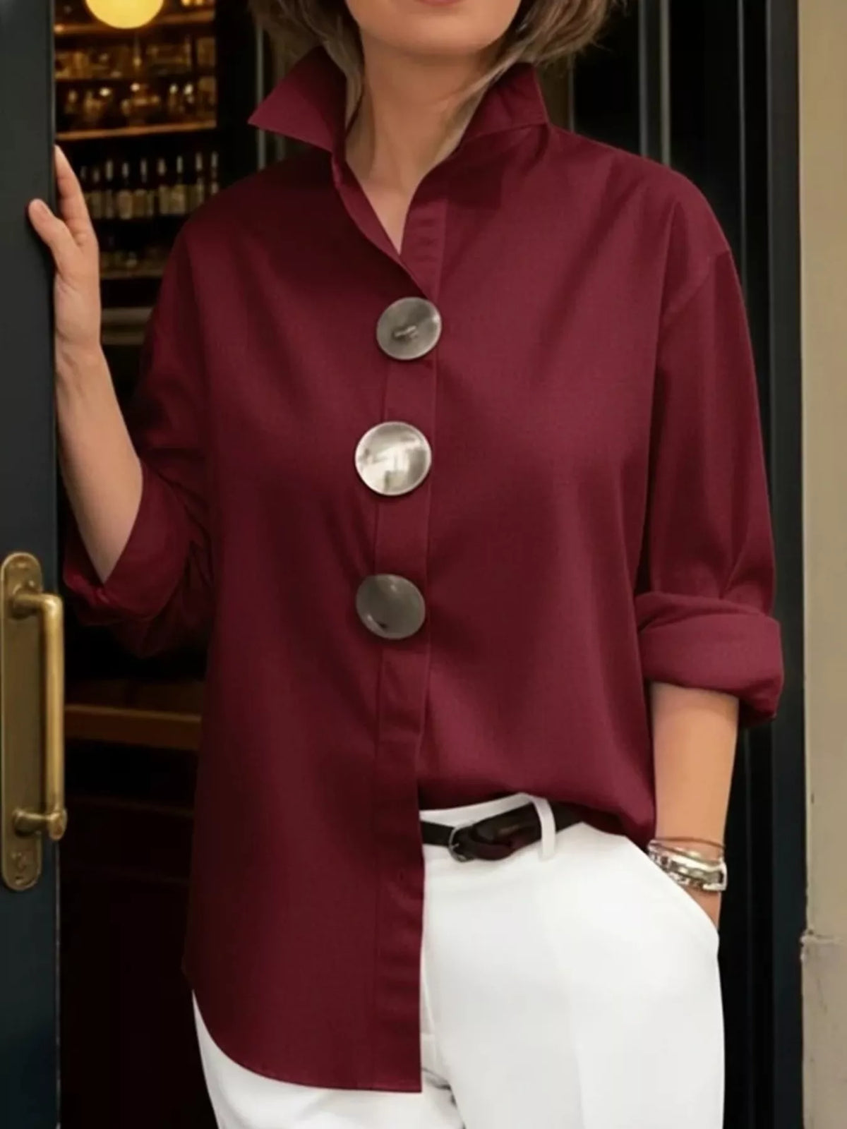 Plus size oversized long sleeve metal button shirt by Trendsi, featuring a relaxed fit and metallic front buttons.