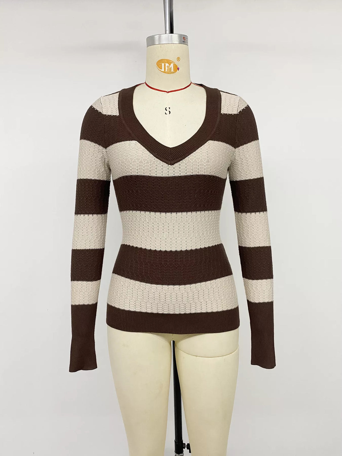 Striped V-neck knit top from Plush Fashion Hub, featuring a fitted design and colorful horizontal stripes.