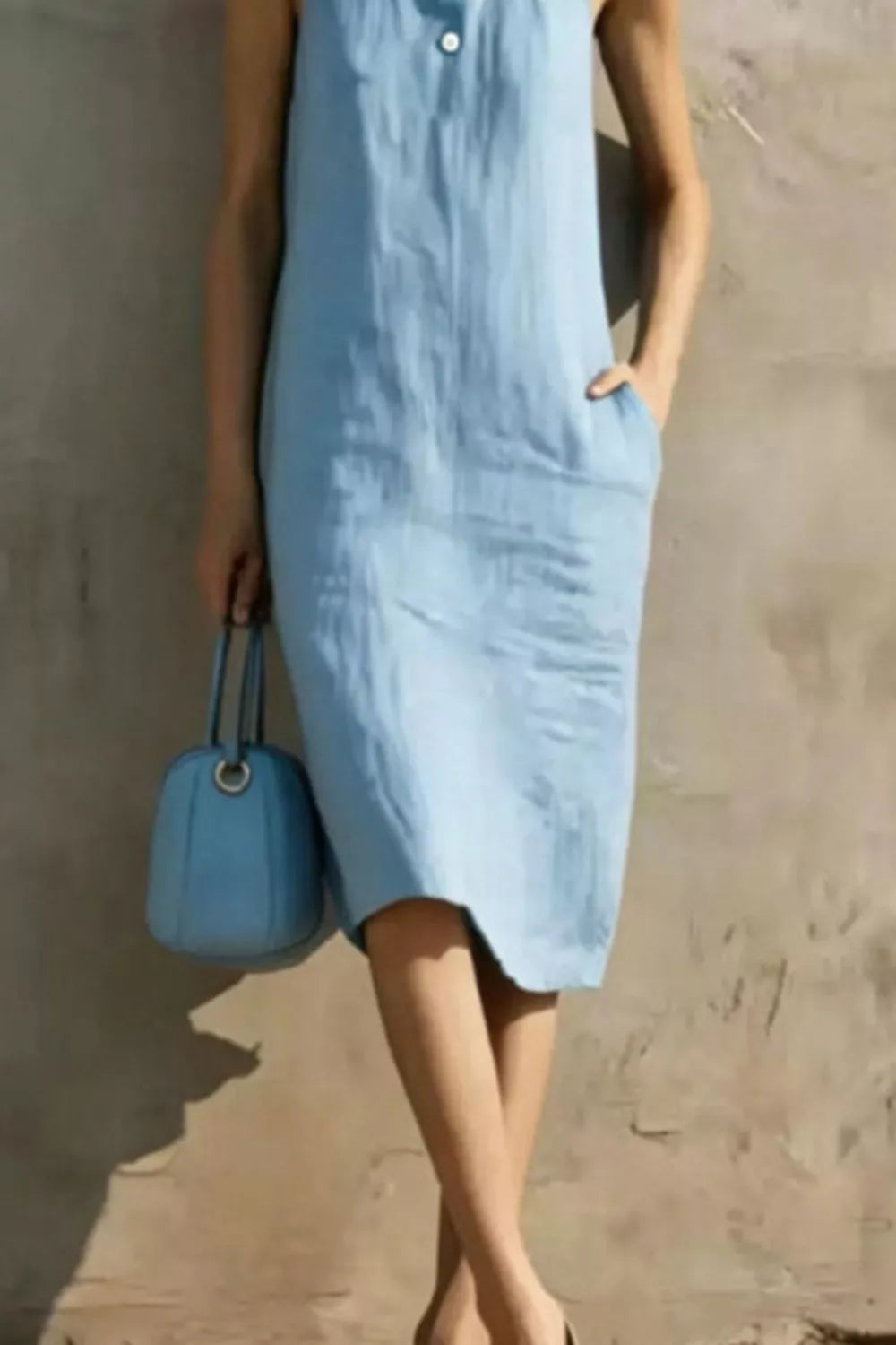 Casual sleeveless midi dress with button details from Plush Fashion Hub, featuring a relaxed fit and stylish design.