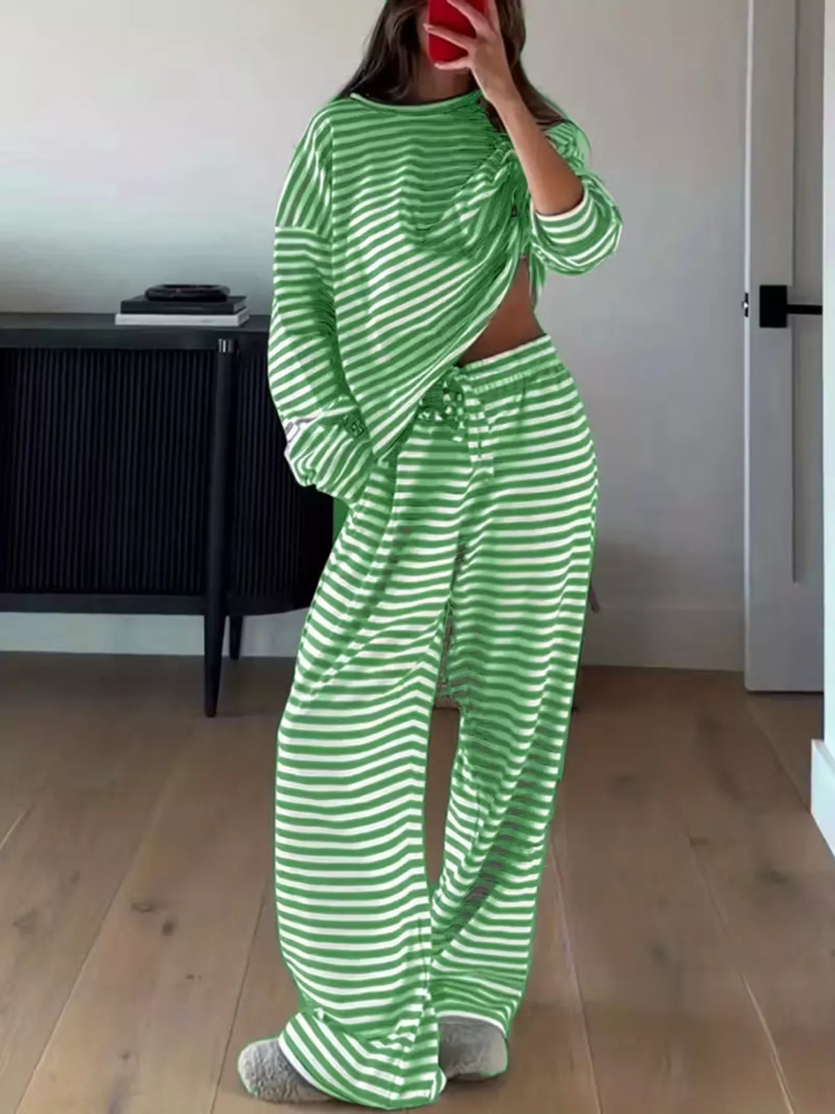 Striped dropped shoulder top and pants set by Trendsi, featuring a casual, stylish design with relaxed fit and comfortable fabric.