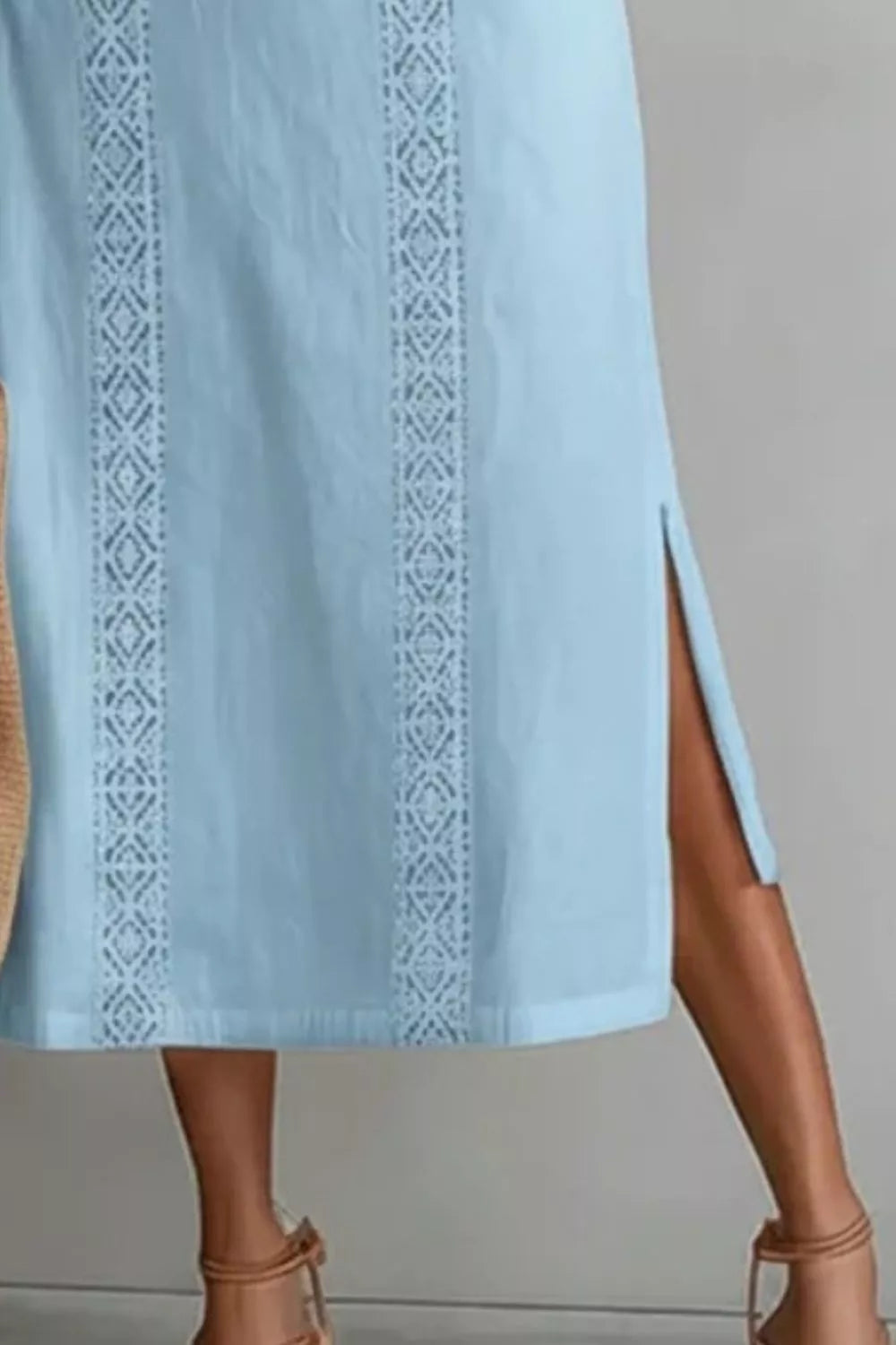 Women's sleeveless side slit maxi dress with pockets from Trendsi, featuring a flowing silhouette and stylish design.