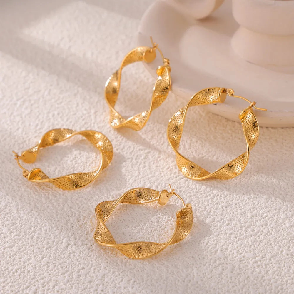Titanium steel twisted earrings from Plush Fashion Hub, featuring sleek, modern design with a polished finish.