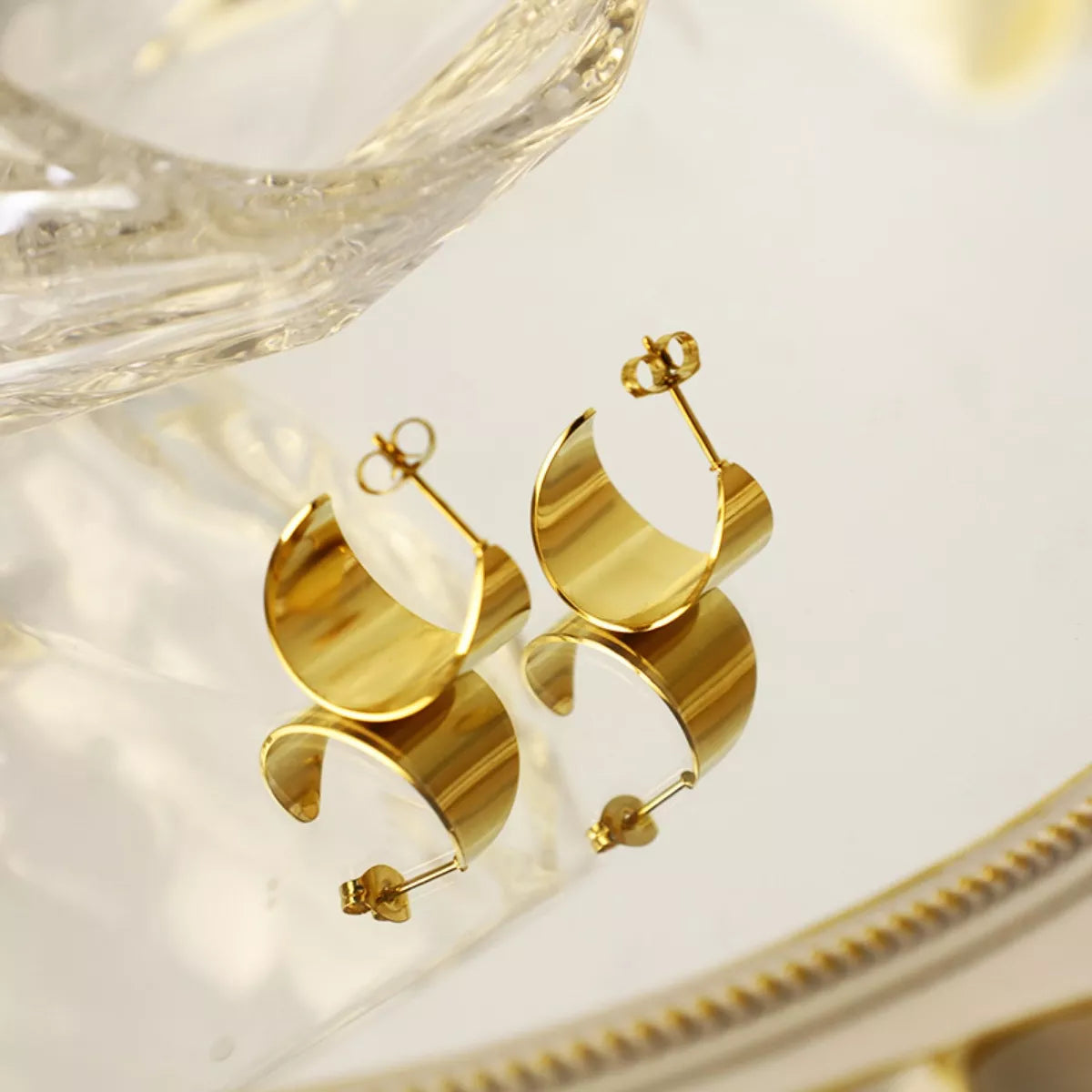 18K gold-plated stud earrings with a sleek, shiny finish, featuring a simple round design for elegant everyday wear.