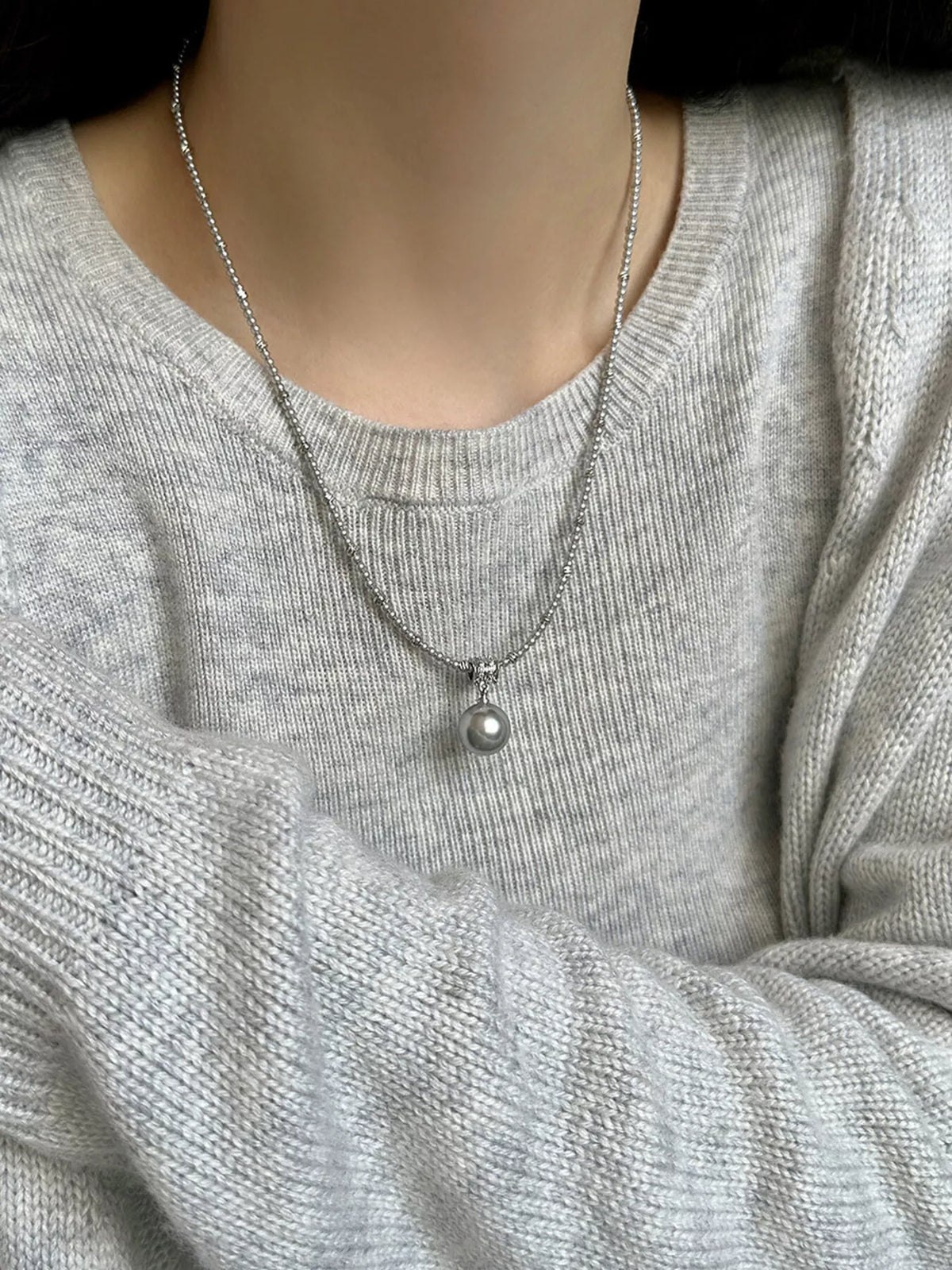Elegant pearl pendant necklace from Plush Fashion Hub featuring a single lustrous pearl on a delicate chain.
