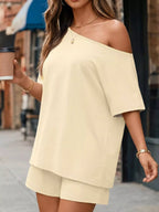 Plus size one-shoulder top and shorts set by Trendsi, featuring a stylish, coordinated look with a fitted top and matching shorts.