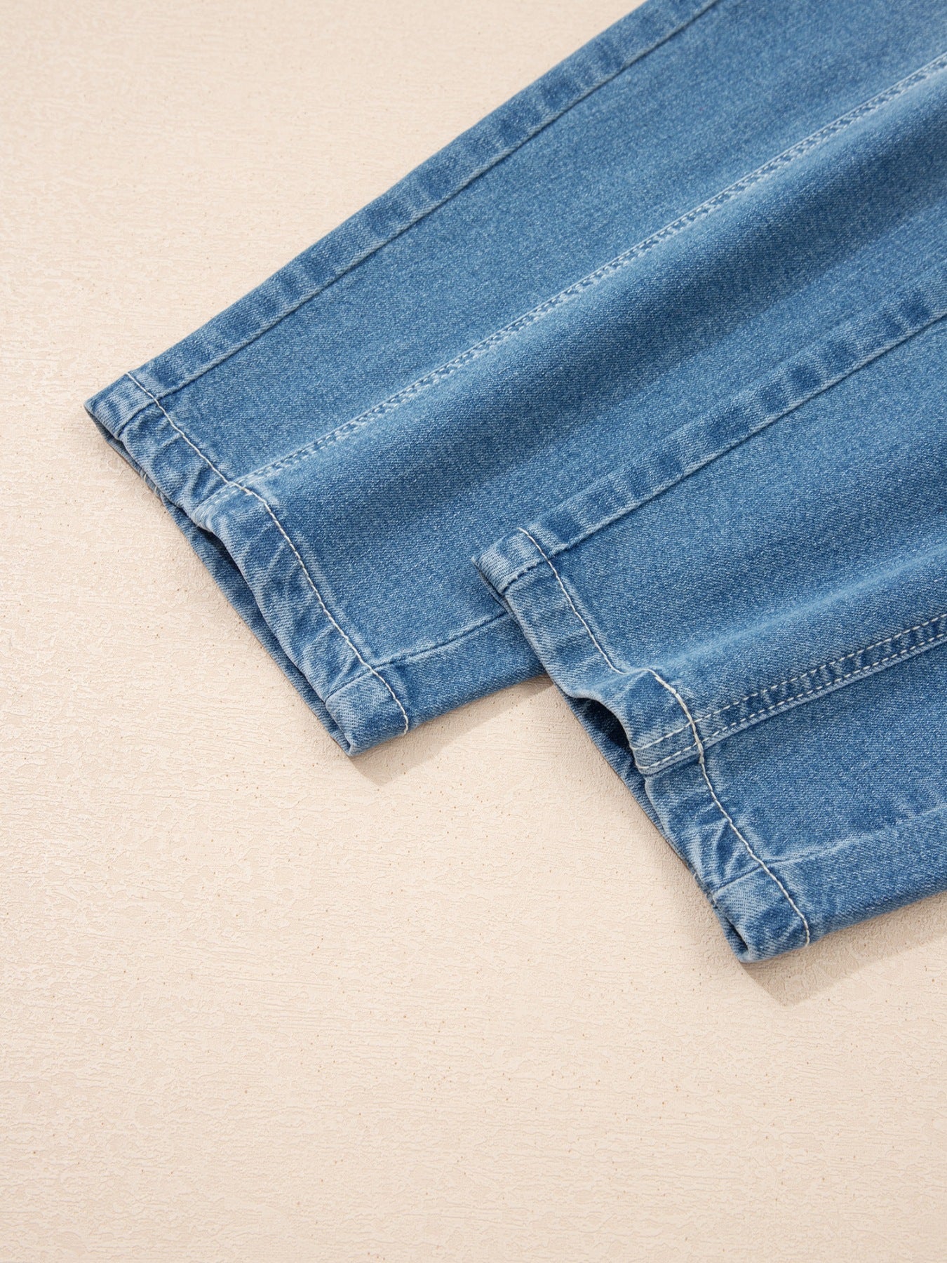 Washed cuffed barrel leg jeans by Trendsi featuring vintage relaxed fit denim bottoms with a casual, distressed look.