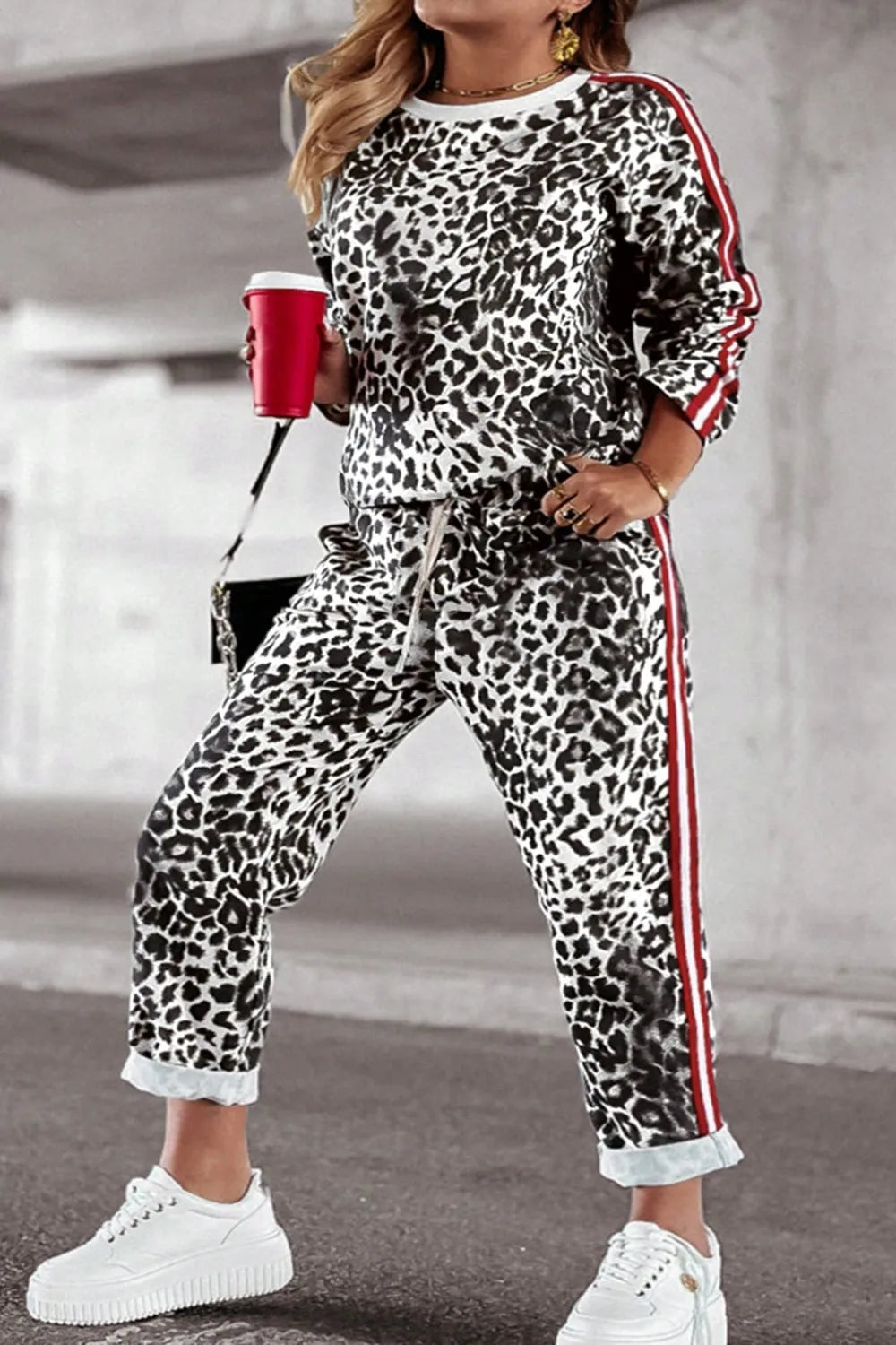 Plus size leopard print round neck top and pants set by Trendsi, featuring a stylish, coordinated matching outfit.