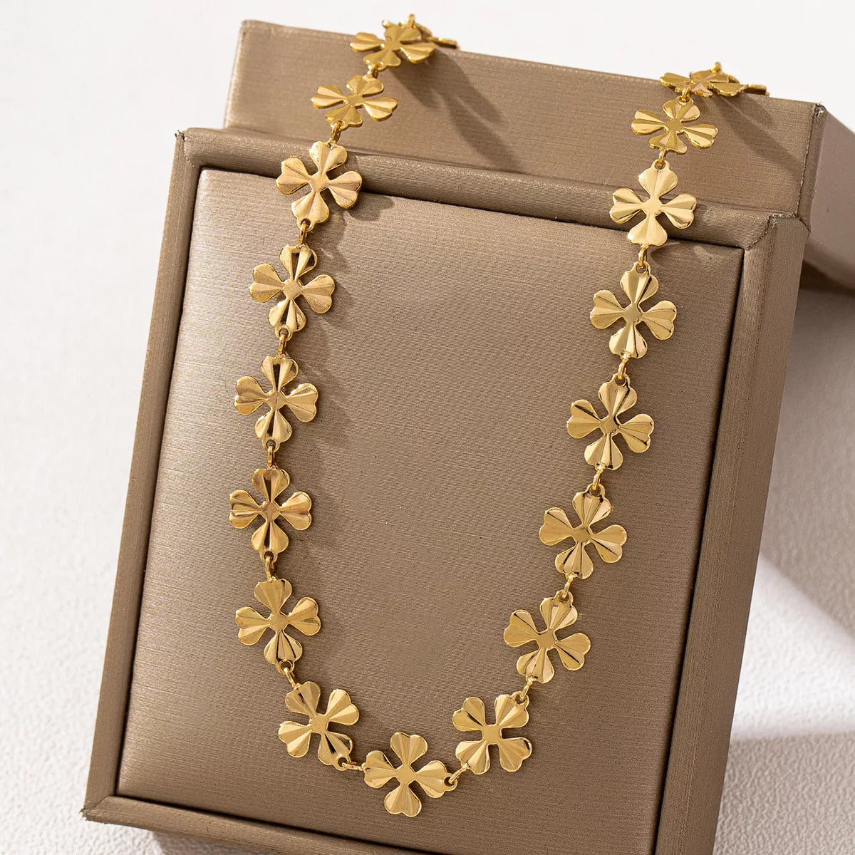 18K gold-plated alloy flower chain necklace showing intricate floral design and shiny gold finish.