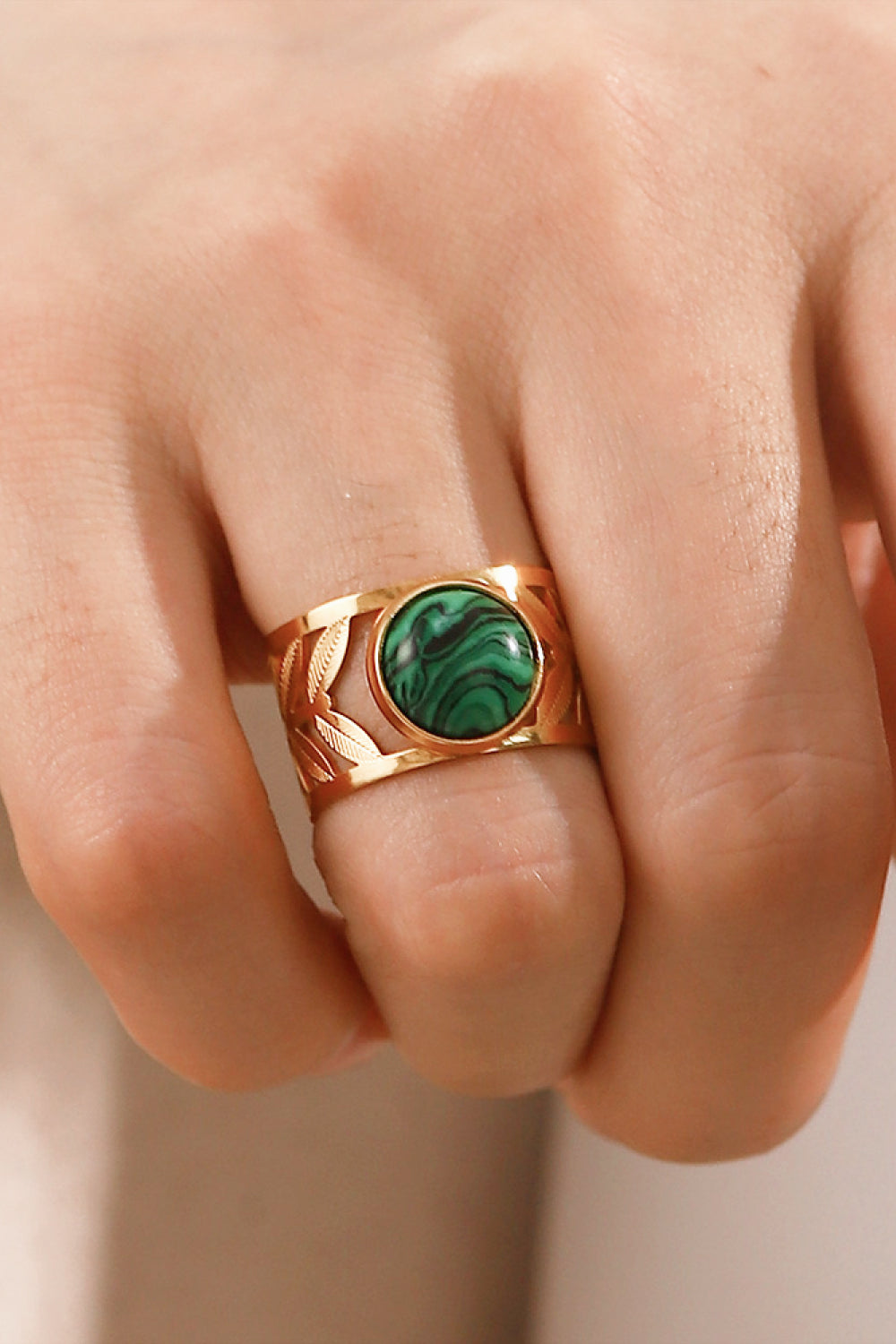 18k gold plated malachite leaf ring showing a detailed green malachite stone set in a gold leaf design.