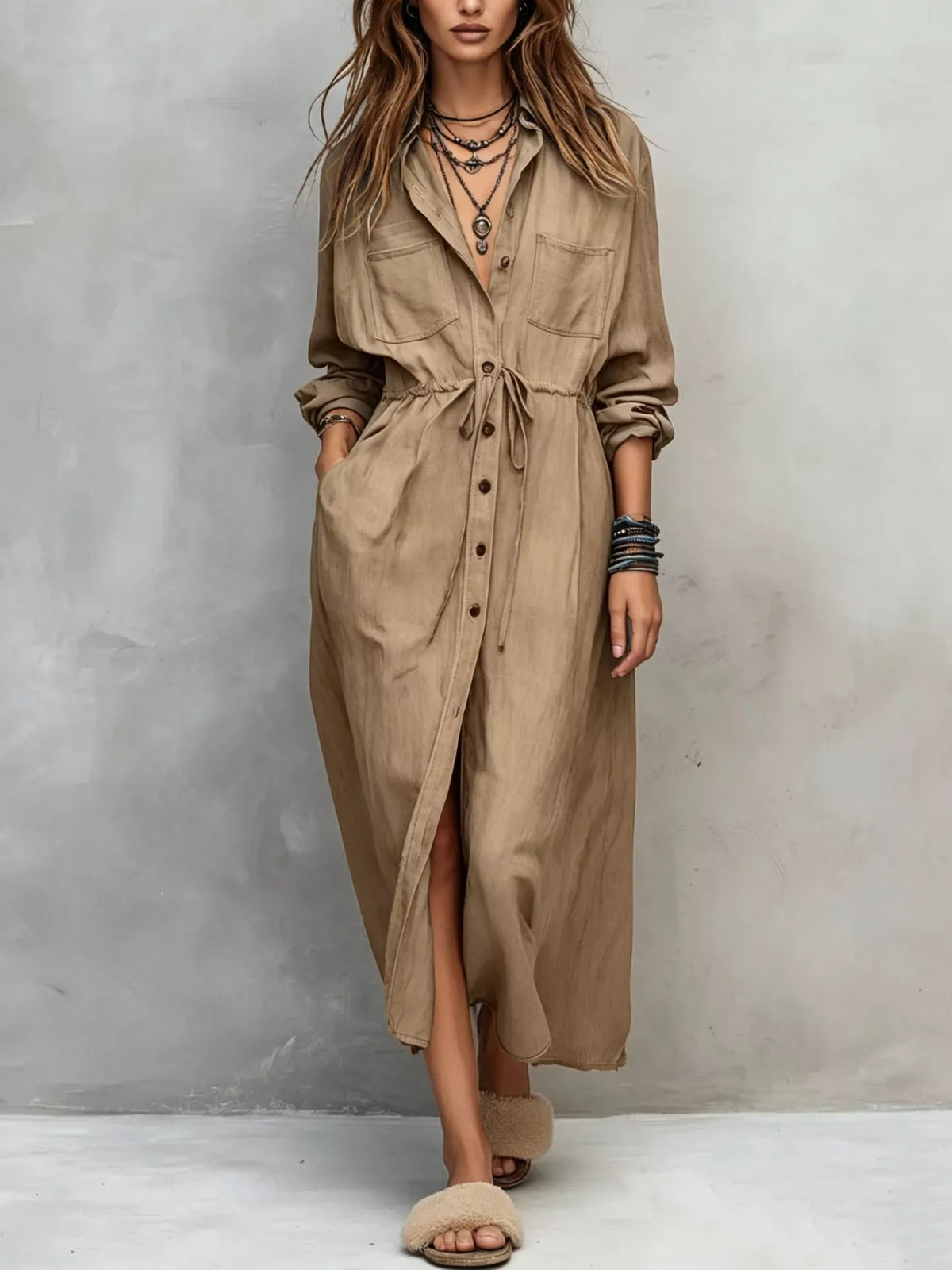 Plus size long sleeve button front shirt dress by Trendsi, shown with a relaxed fit, collar, and front button closure.