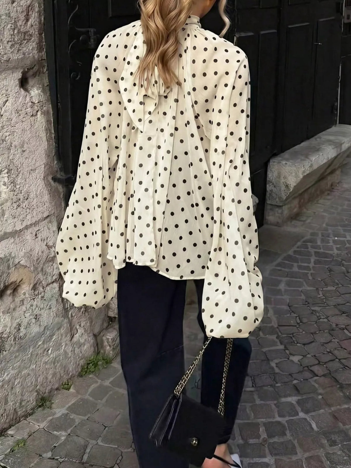 Polka dot balloon sleeve blouse for women by Trendsi, featuring a stylish design with puffed sleeves and a classic pattern.