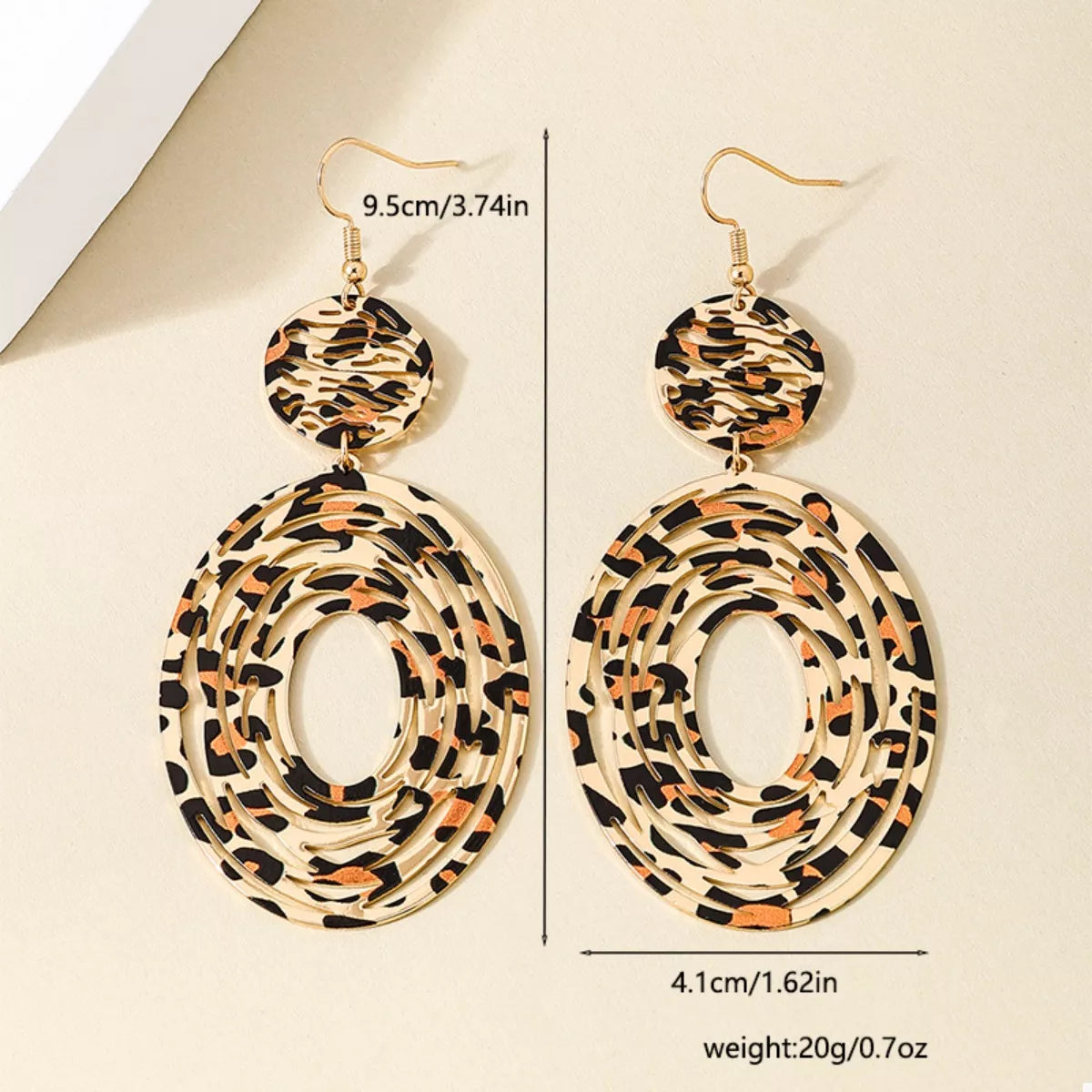 Leopard print dangle earrings by Plush Fashion Hub featuring gold hooks and bold animal print design.