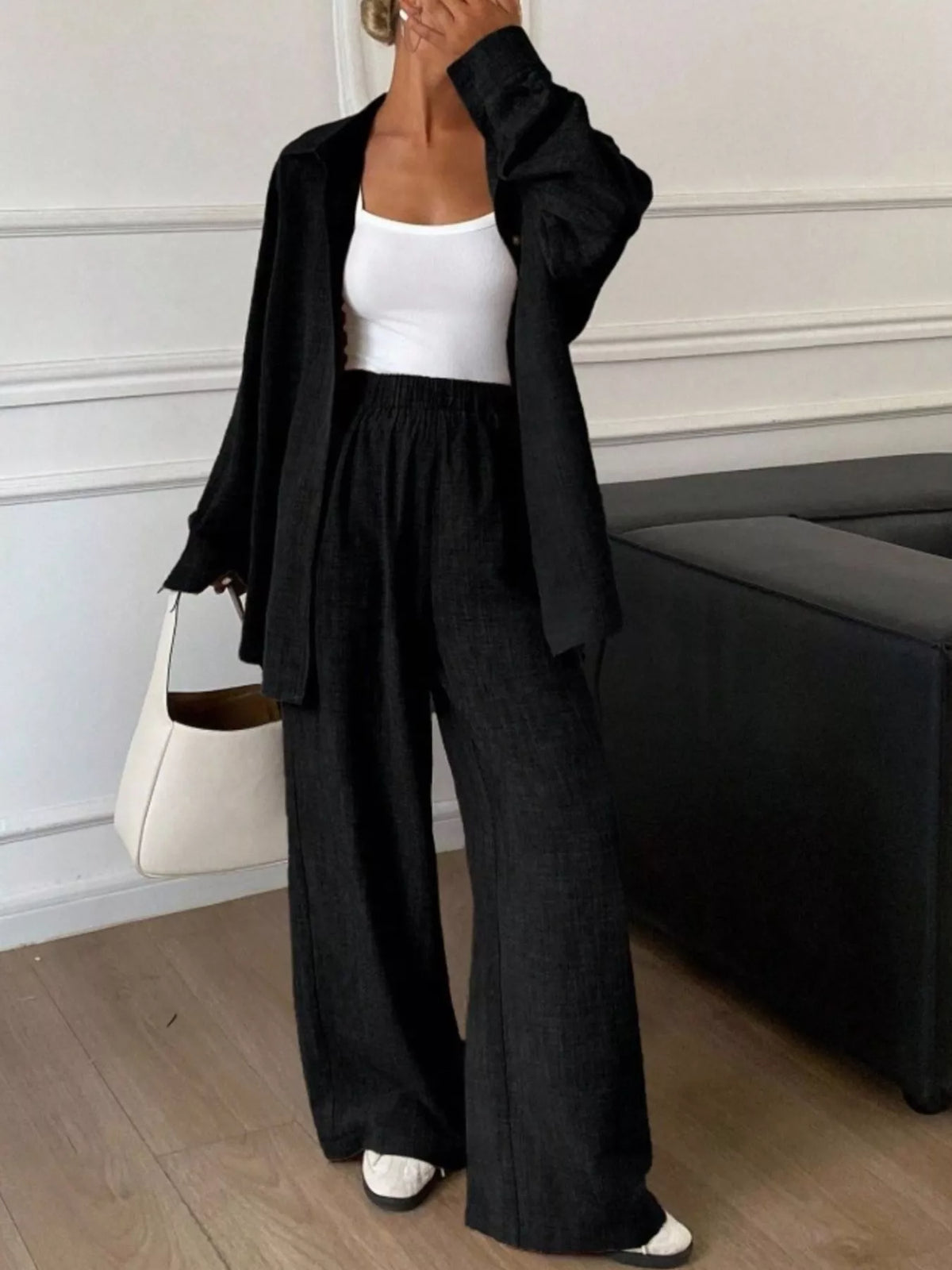 Trendsi long sleeve button-up shirt and wide-leg pants set, featuring a stylish coordinated outfit with a fitted shirt and flowy pants.
