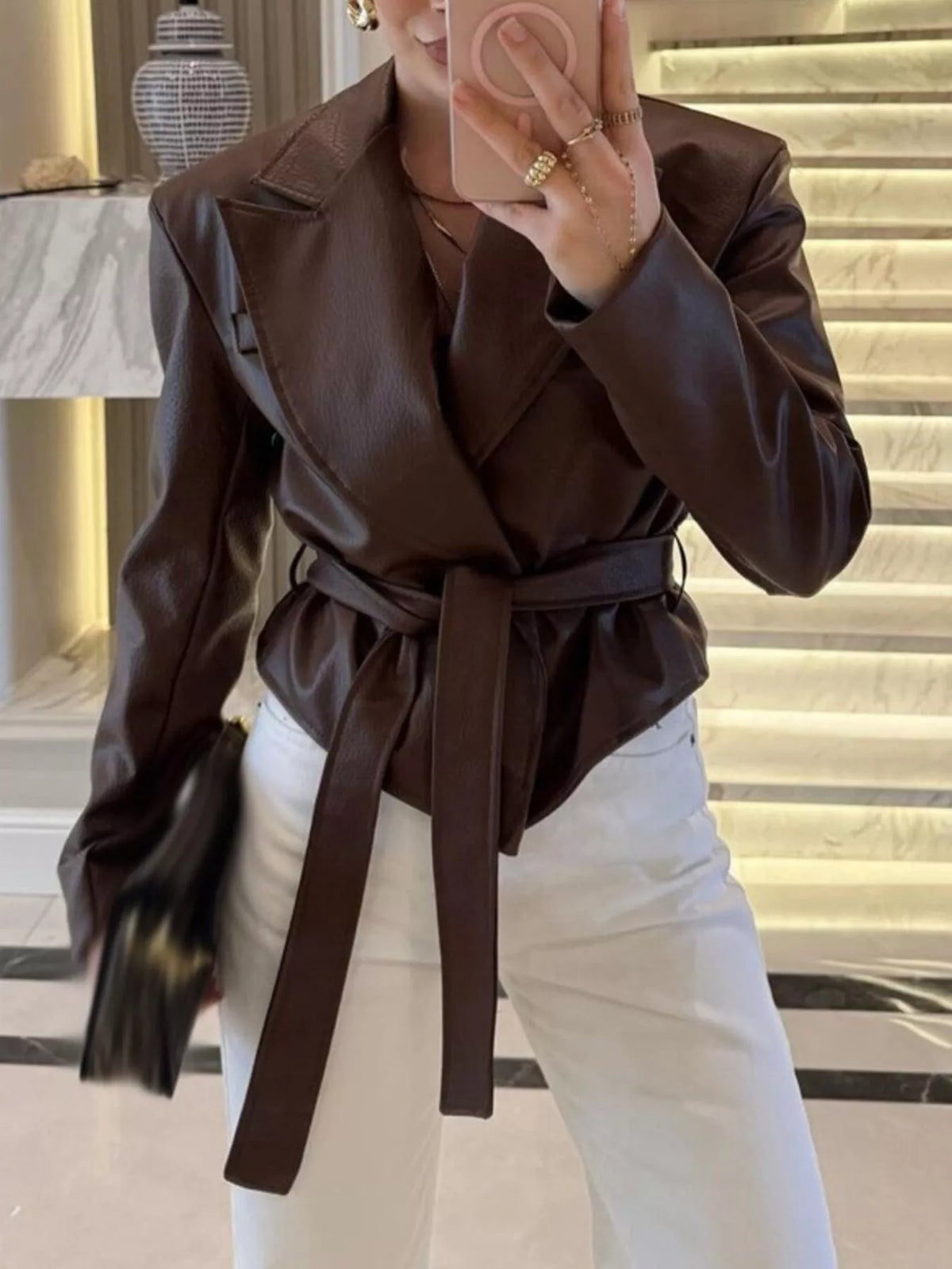 Women's leather belted jacket with shawl collar, stylish and fitted, featuring a smooth leather finish and classic design.