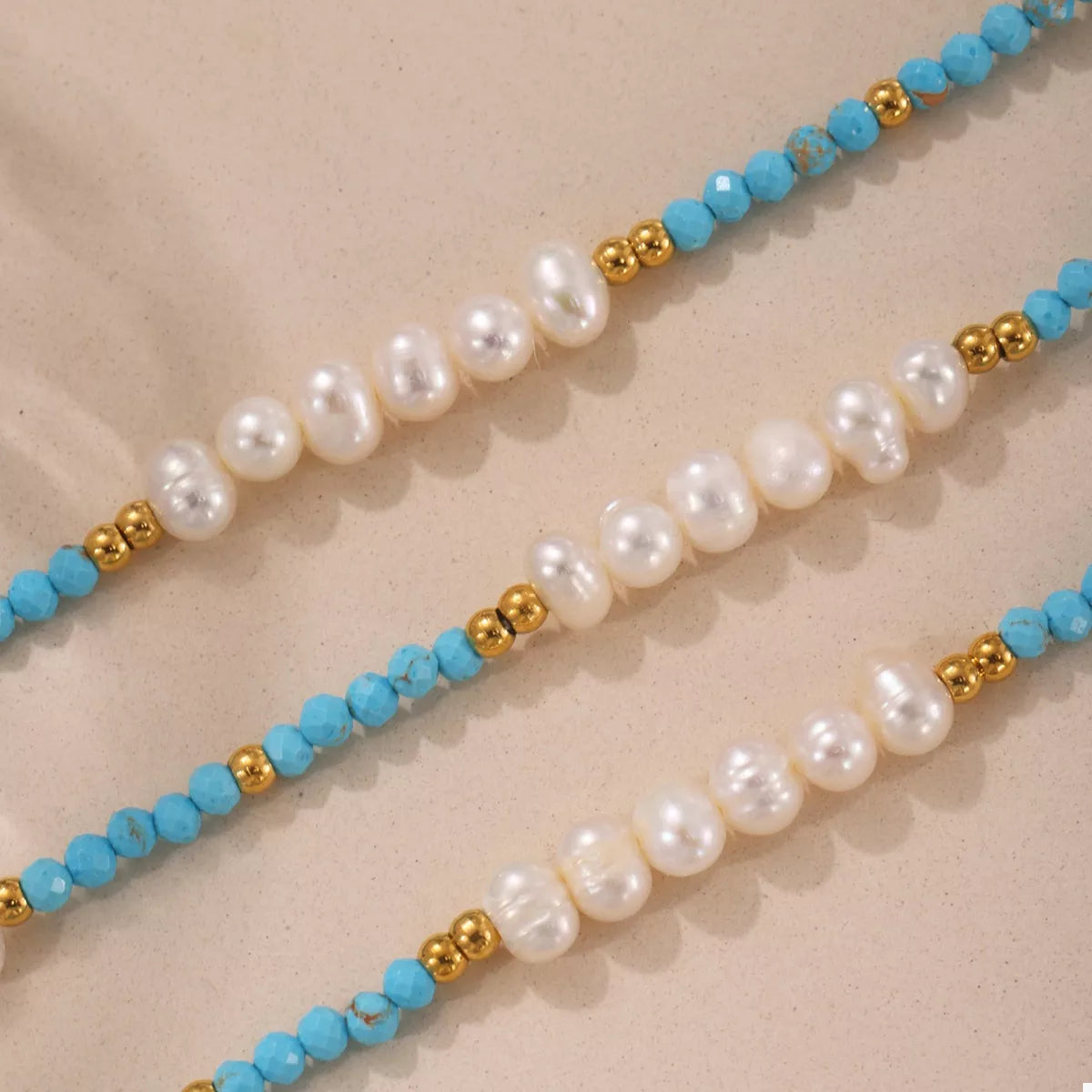 Turquoise pearl beaded necklace from Plush Fashion Hub featuring multiple strands of glossy pearls and a delicate clasp.